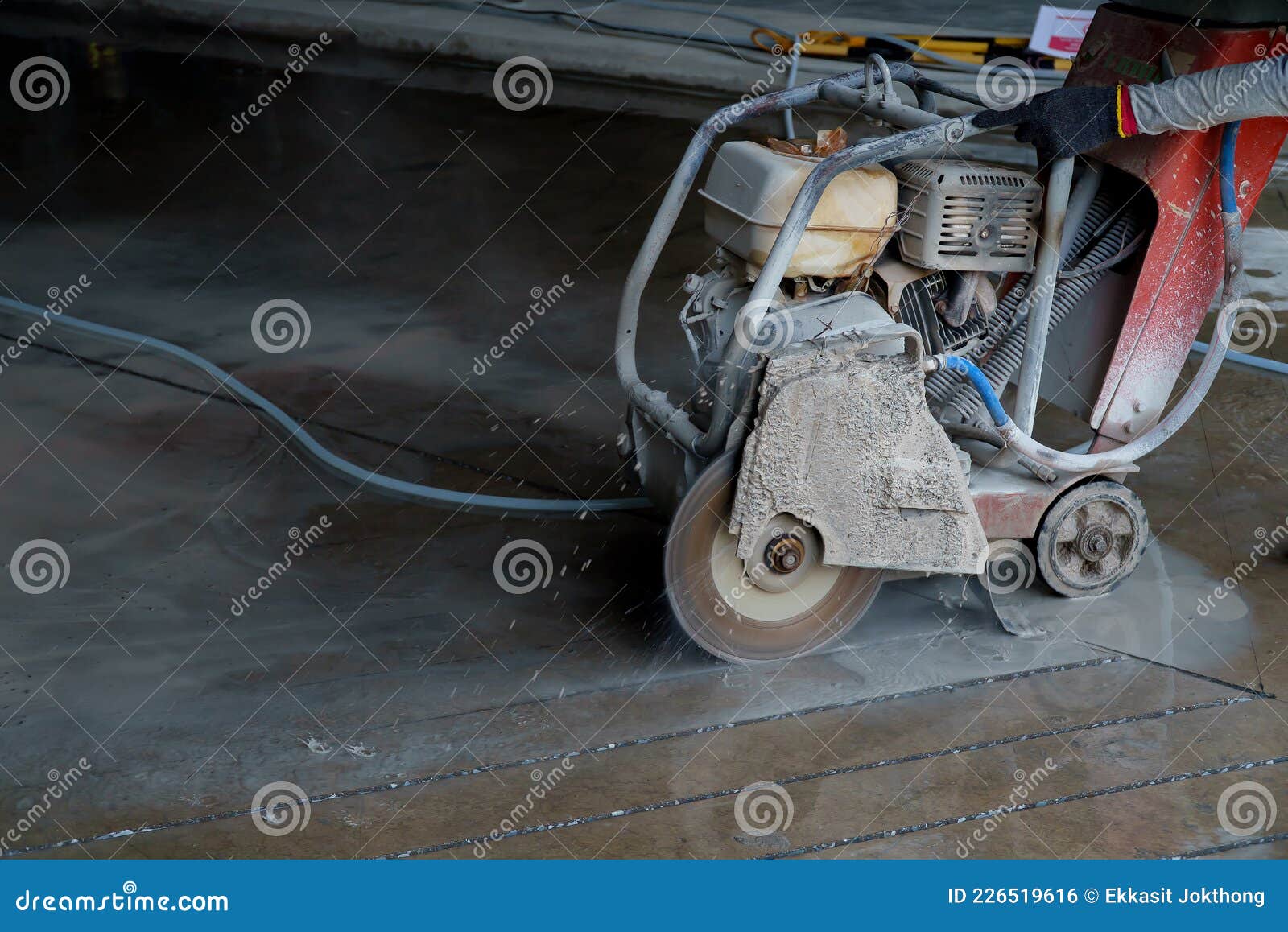 A Machine is Using Blades To Cut Concrete Slabs To Make Grooves in a