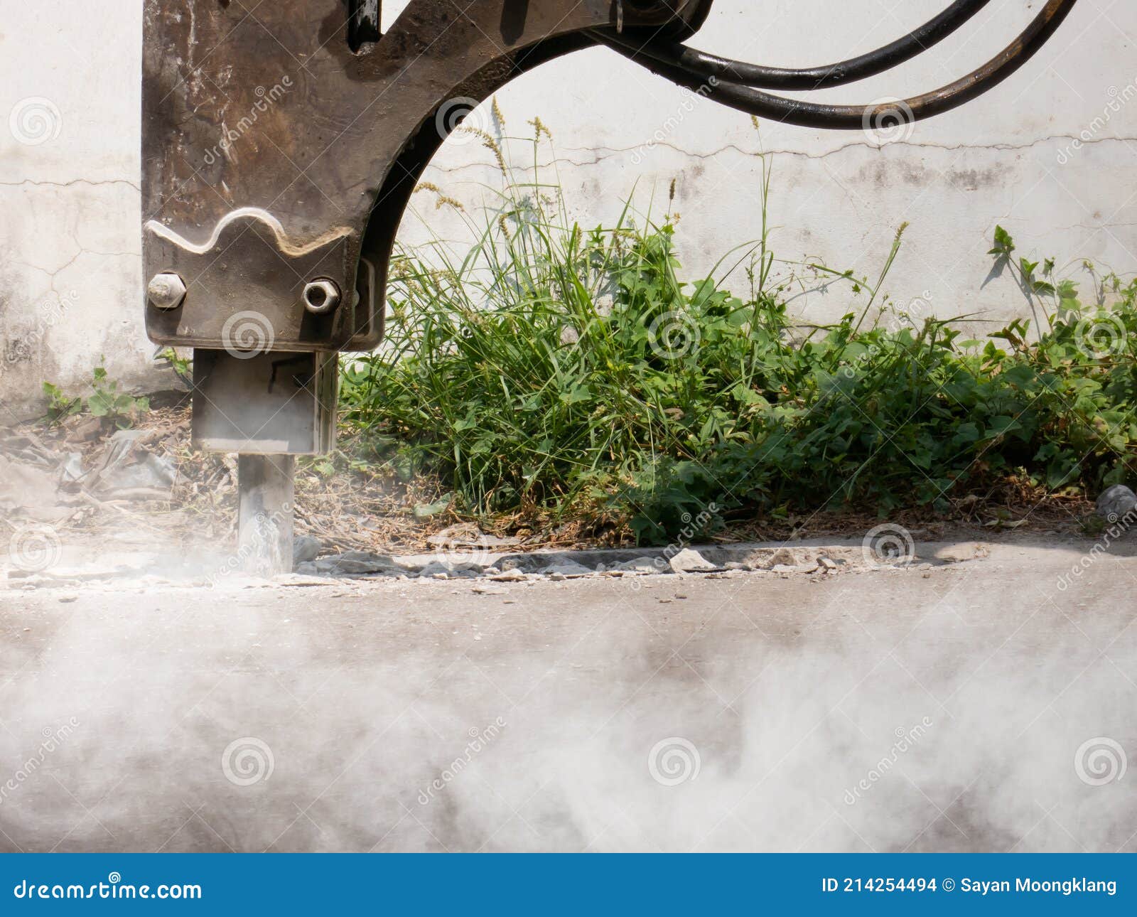 Machine is Working To Drill the Concrete Pavement Causing Dust Smoke