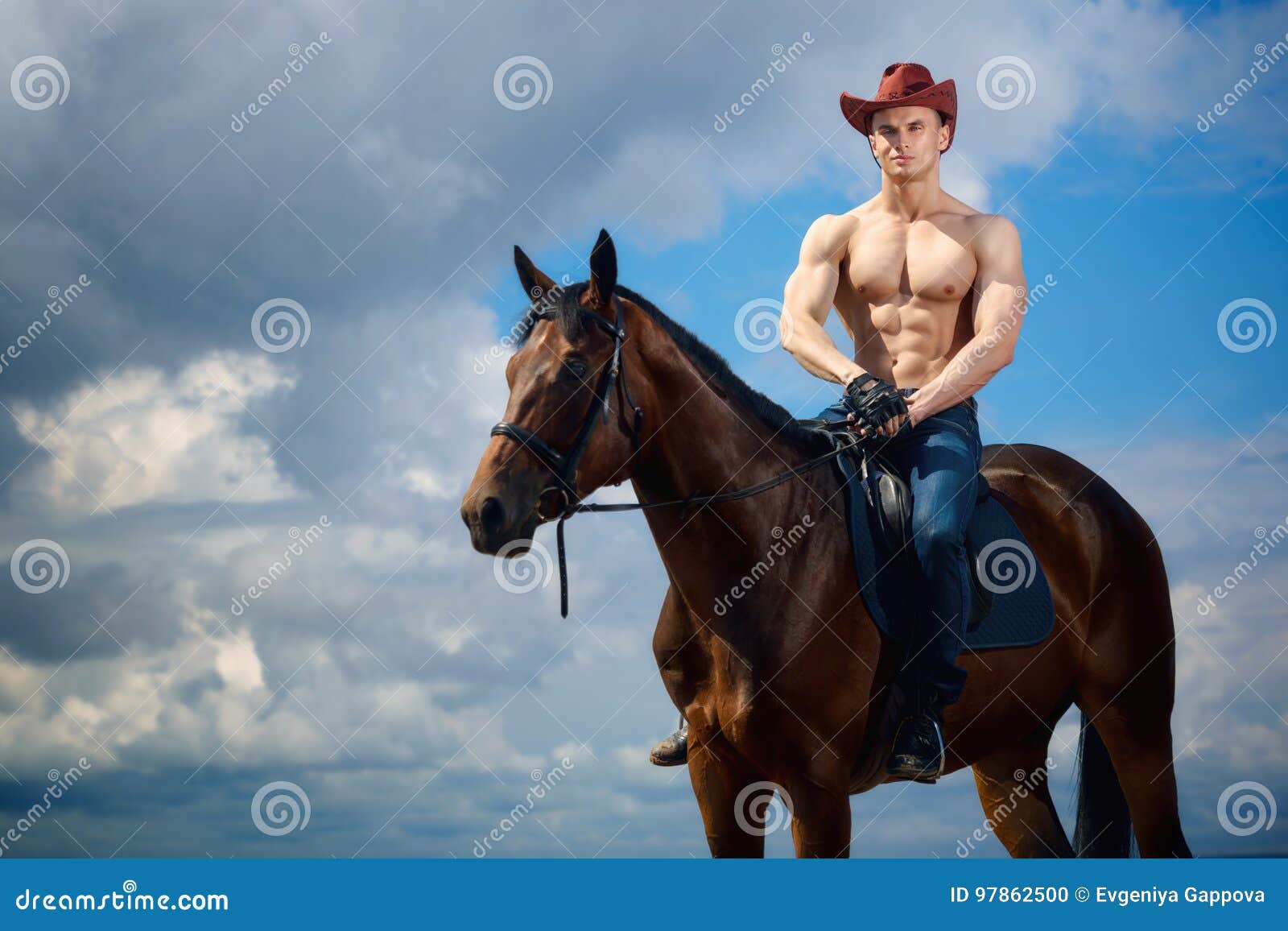 macho man handsome cowboy and horse on the background of sky and water.