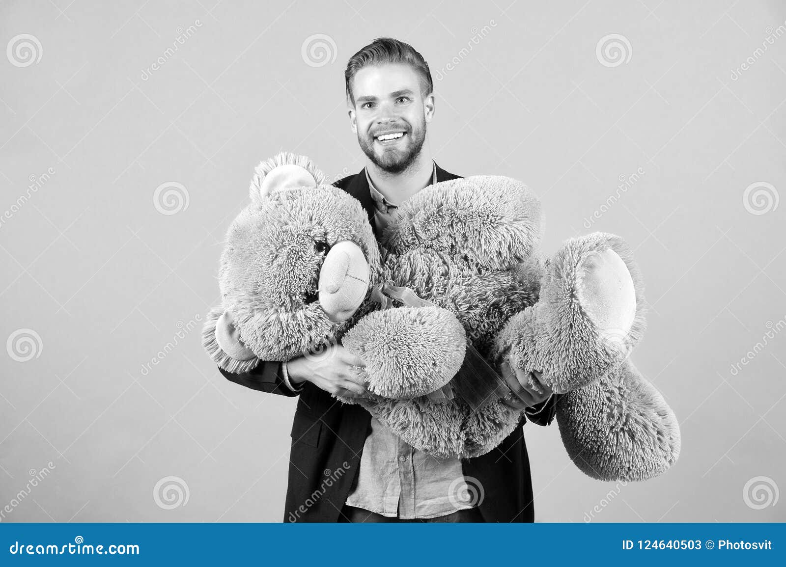macho smile with grey teddy bear. happy man big animal toy. man smile with big animal toy. gift and present concept