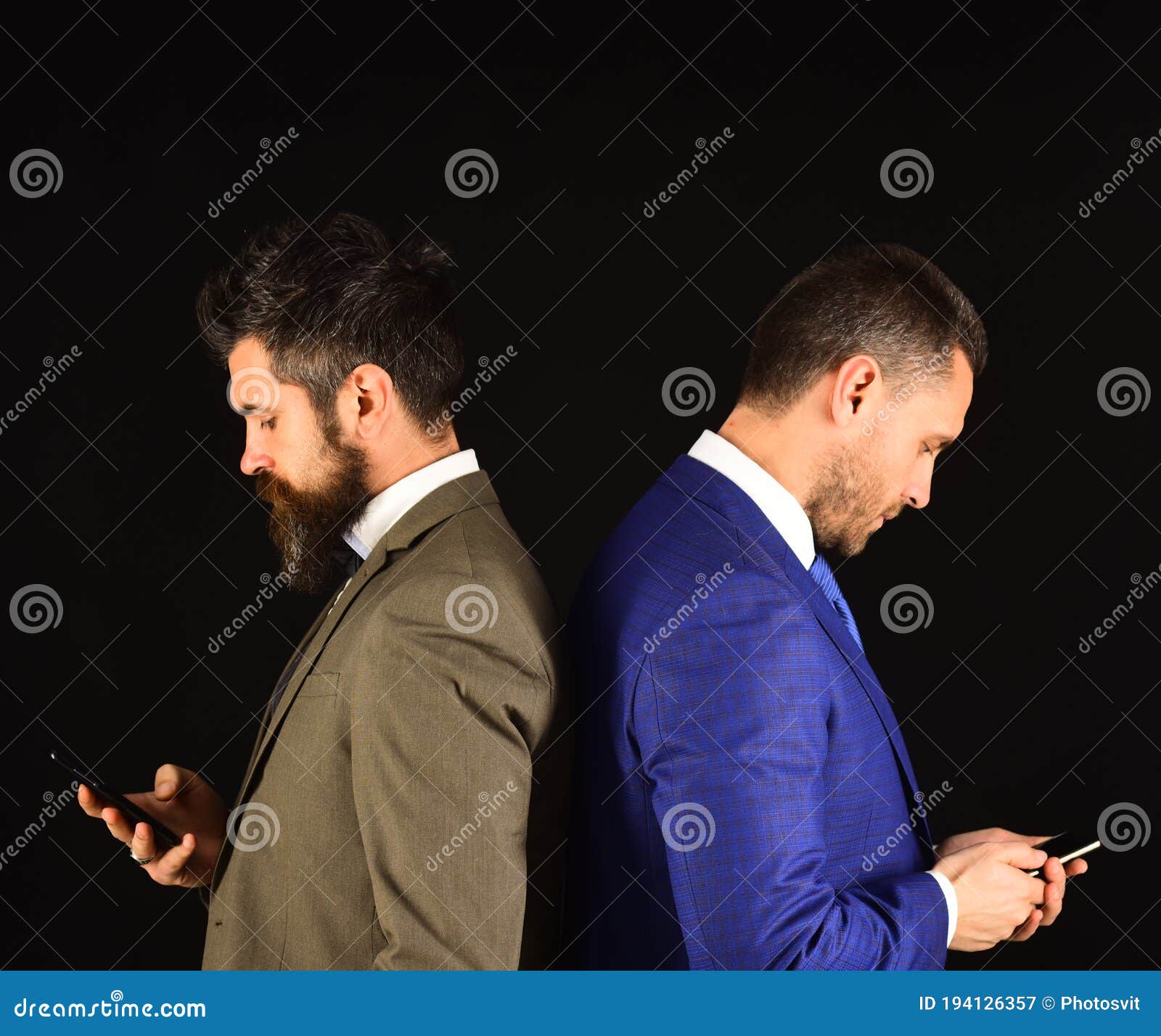 machos in classic suits text on mobile phone.