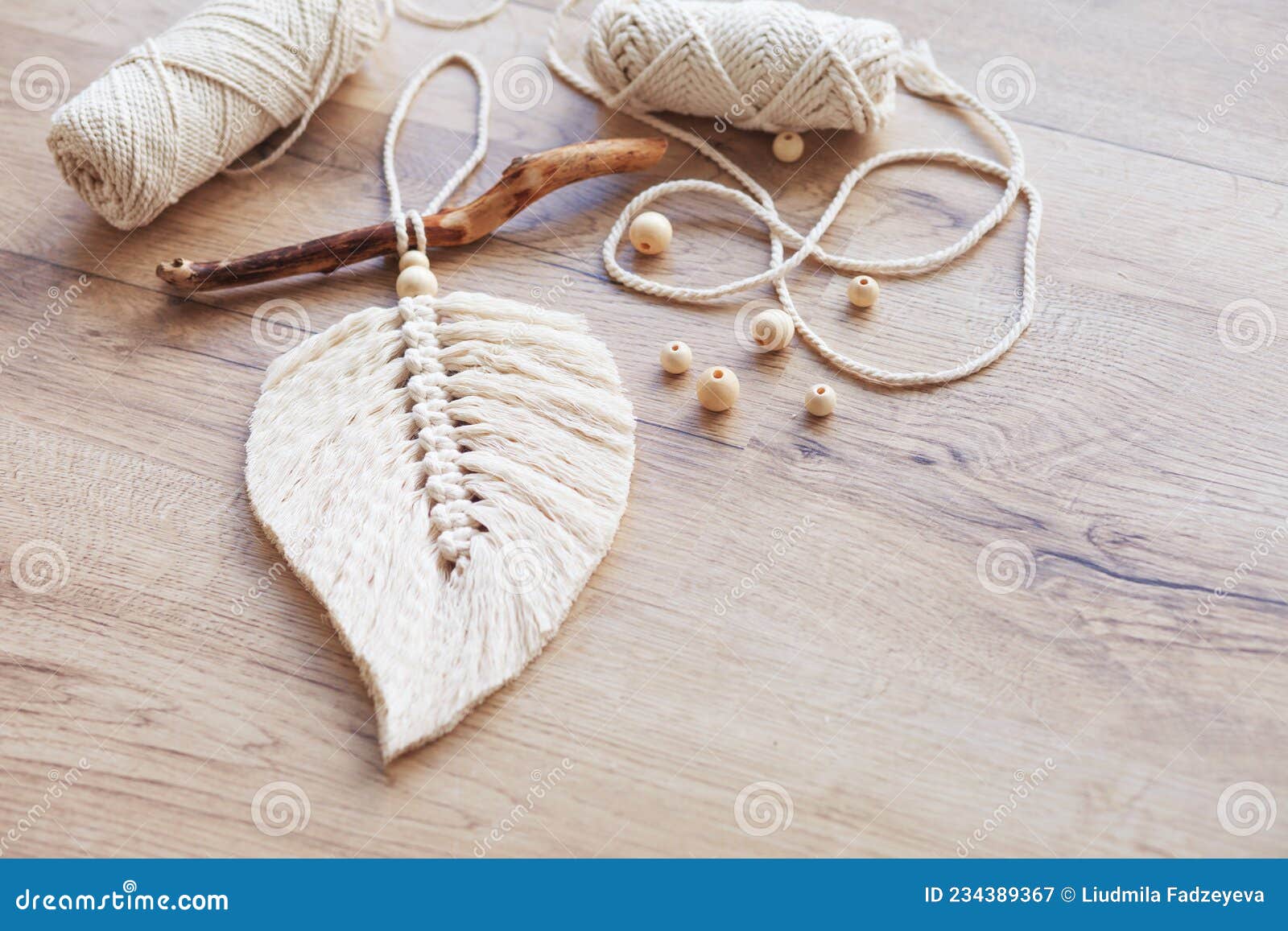 Macrame Leaf in Natural Color and Thread Windings Lying on a