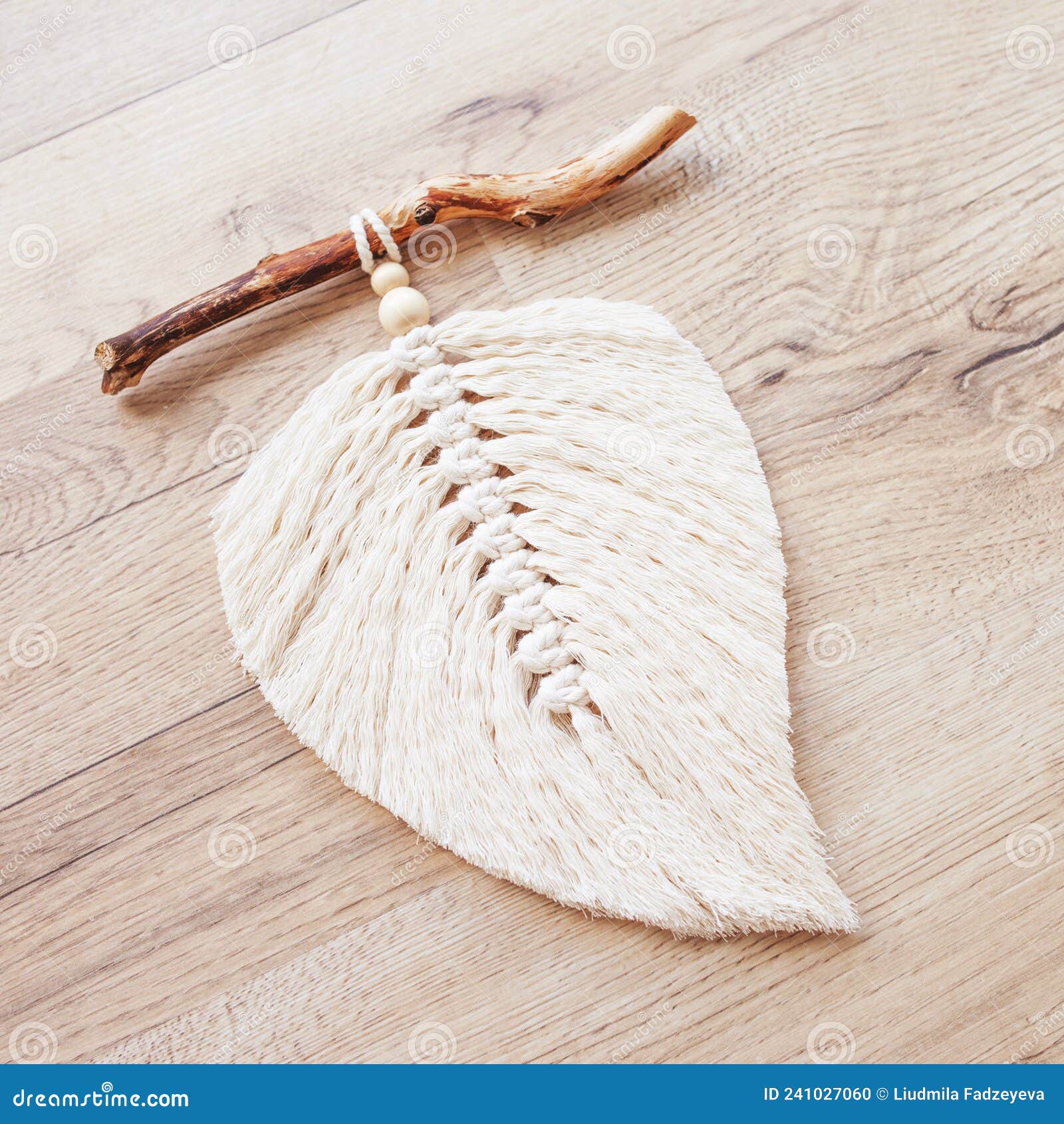Macrame Leaf in Natural Color on a Wooden Table. Cotton Rope Decor