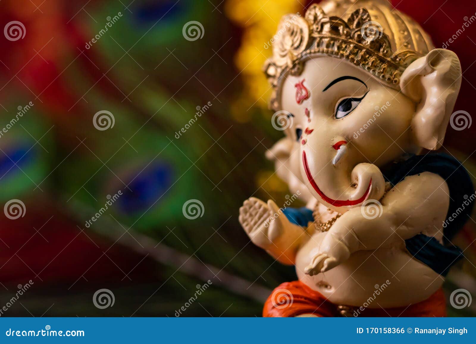 Macro Close Up of Beautiful Ganesha Statue Against Blurry Red Golden ...