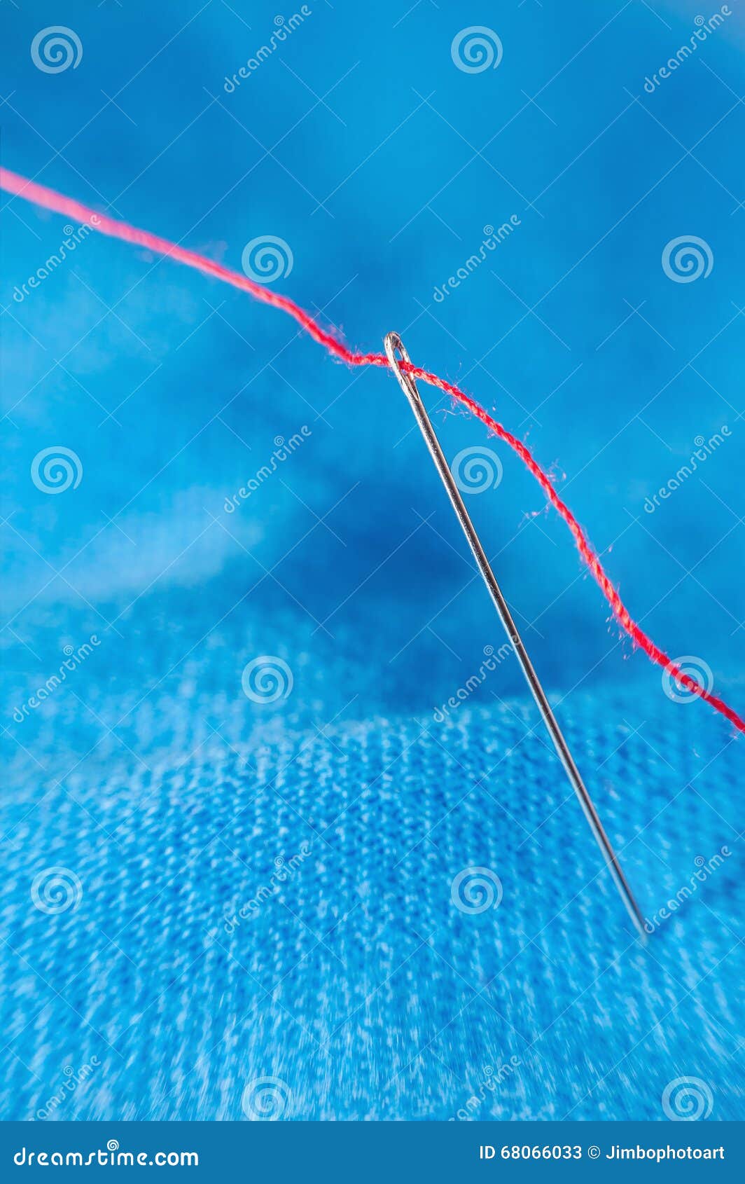 Macro Red Thread through Needle Hole on Blue Blurred Background Stock ...