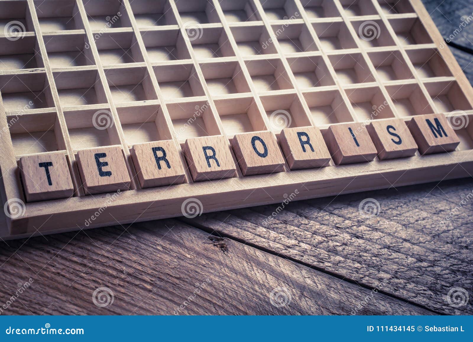 Macro of the Word Terrorism Formed by Wooden Blocks in a Typecase Stock