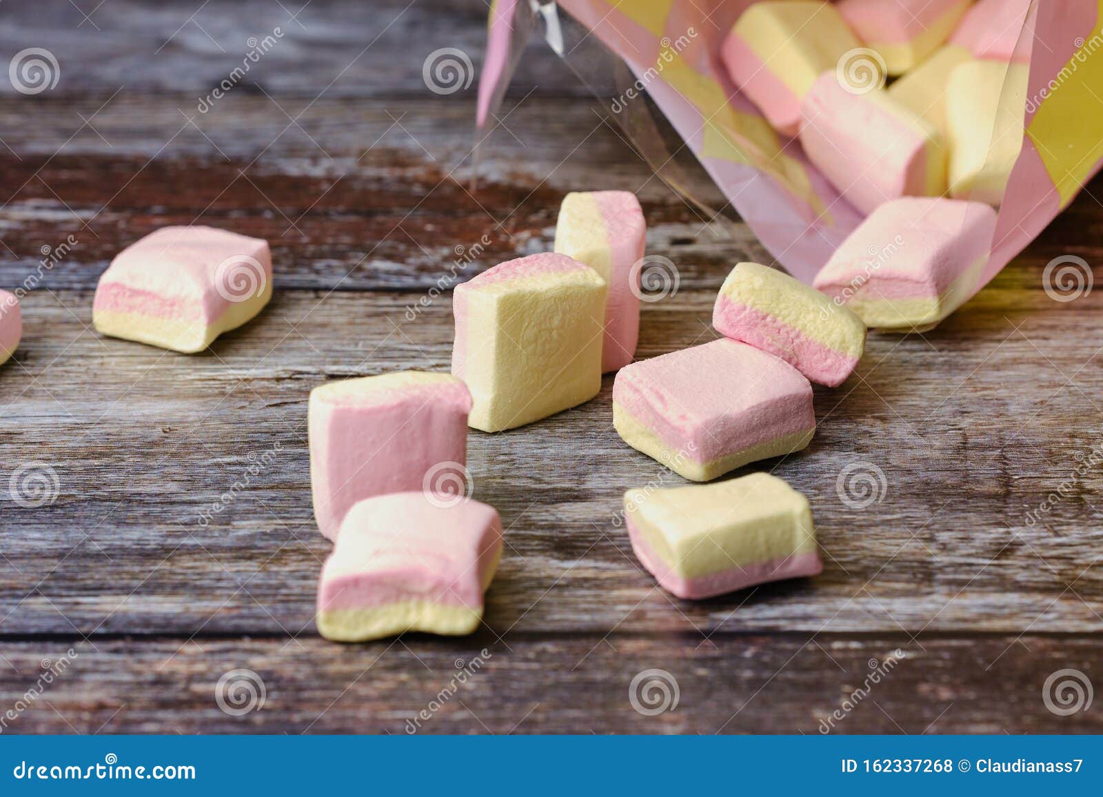 Macro of Yellow and Pink Marshmallows Lying in Front of a Plastic Bag
