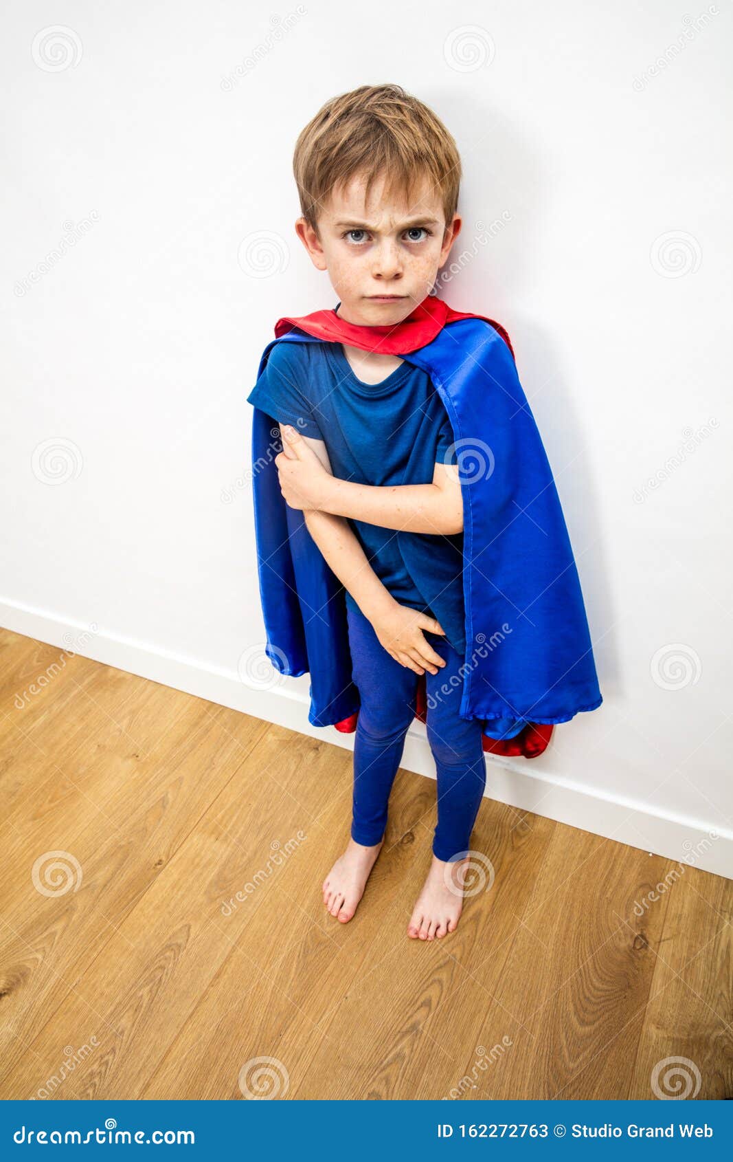 mad little superhero child conflicted by parents for domestic violence