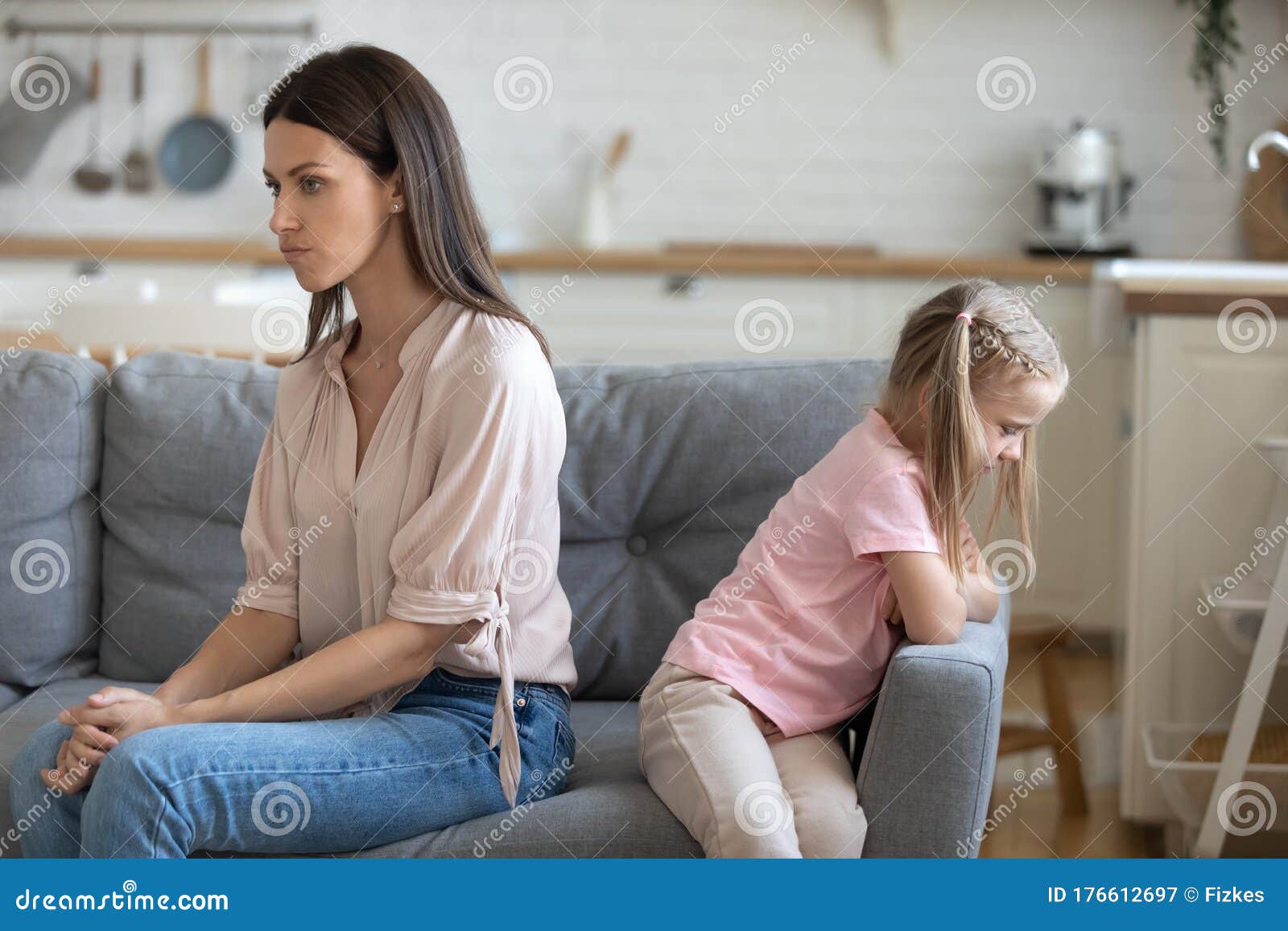 Mad Young Mom And Little Daughter Sit Separately After Fight Stock