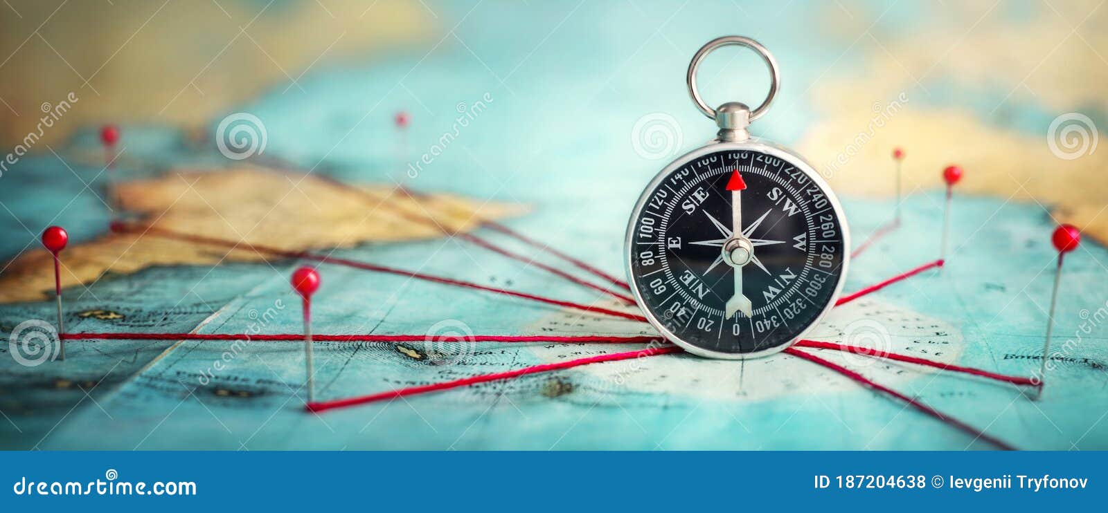 magnetic compass  and location marking with a pin on routes on world map. adventure, discovery, navigation, communication,