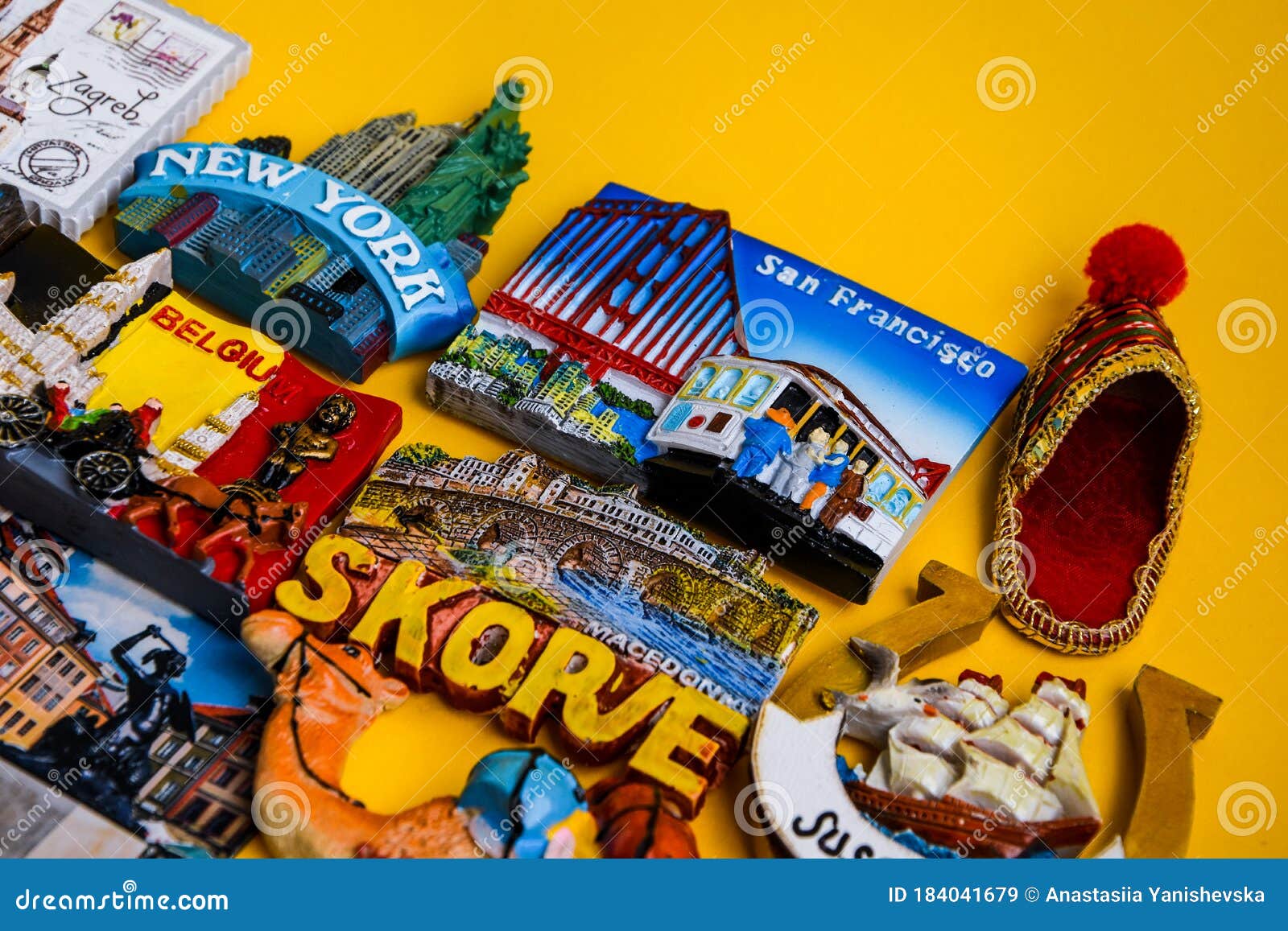 Magnets from Different Countries on Yellow Background, Travel Concept