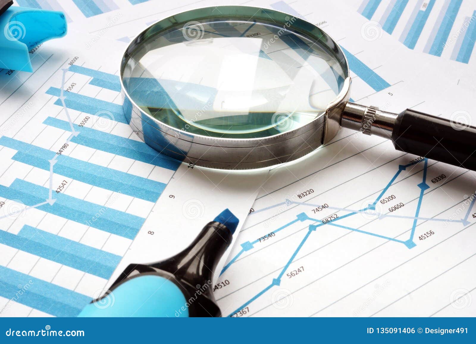 Magnifying glass and financial documents. Audit and accounting