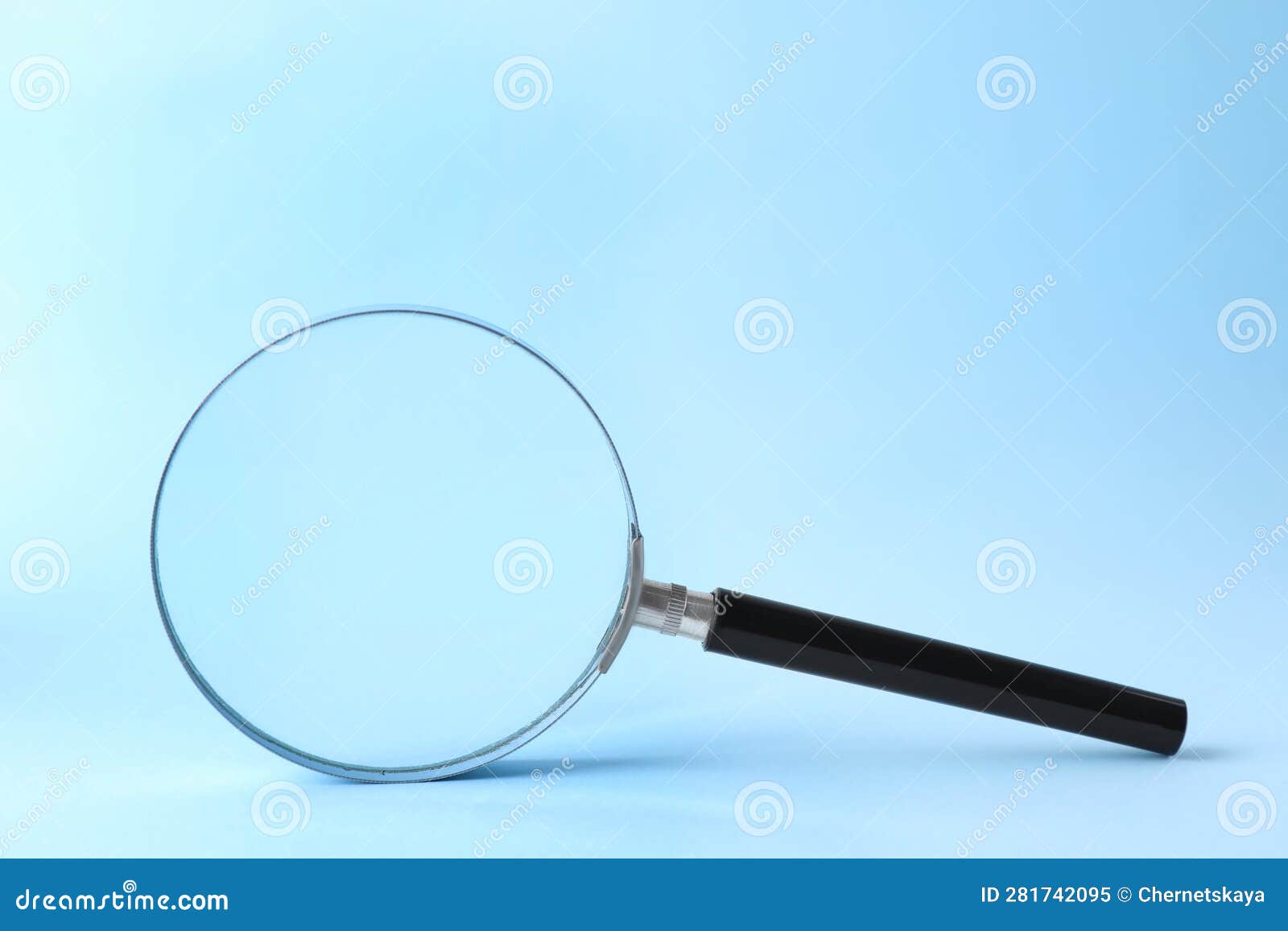 Magnifying Glass with Handle on Light Blue Background Stock Image