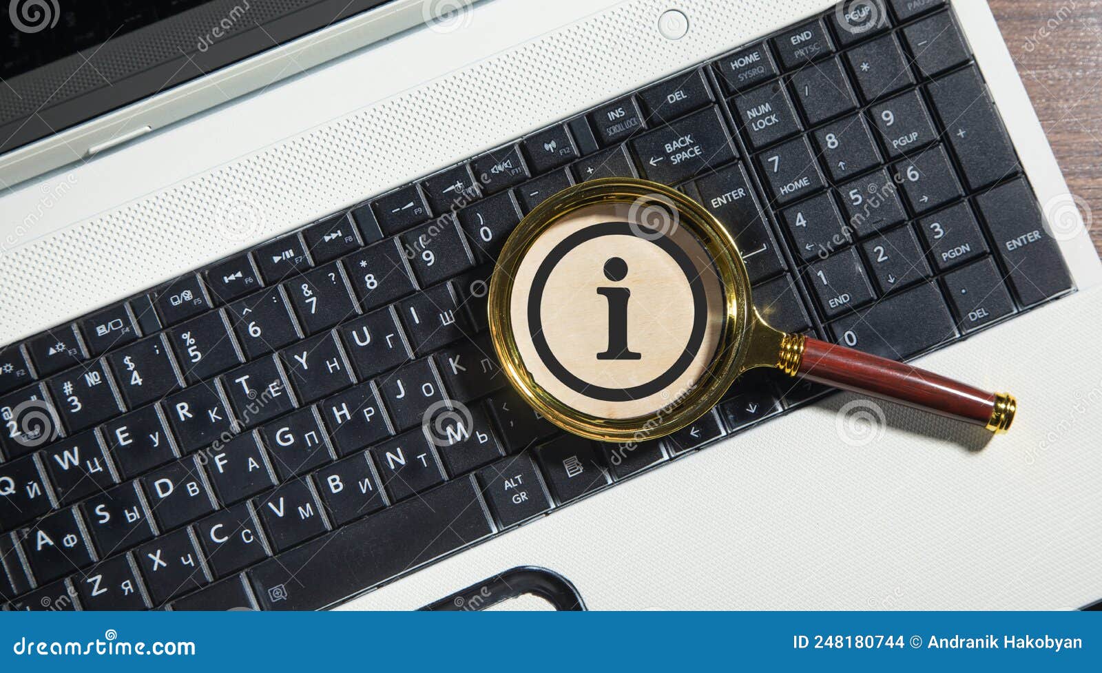 Magnifying Glass with a Information Symbol on the Computer Keyboard