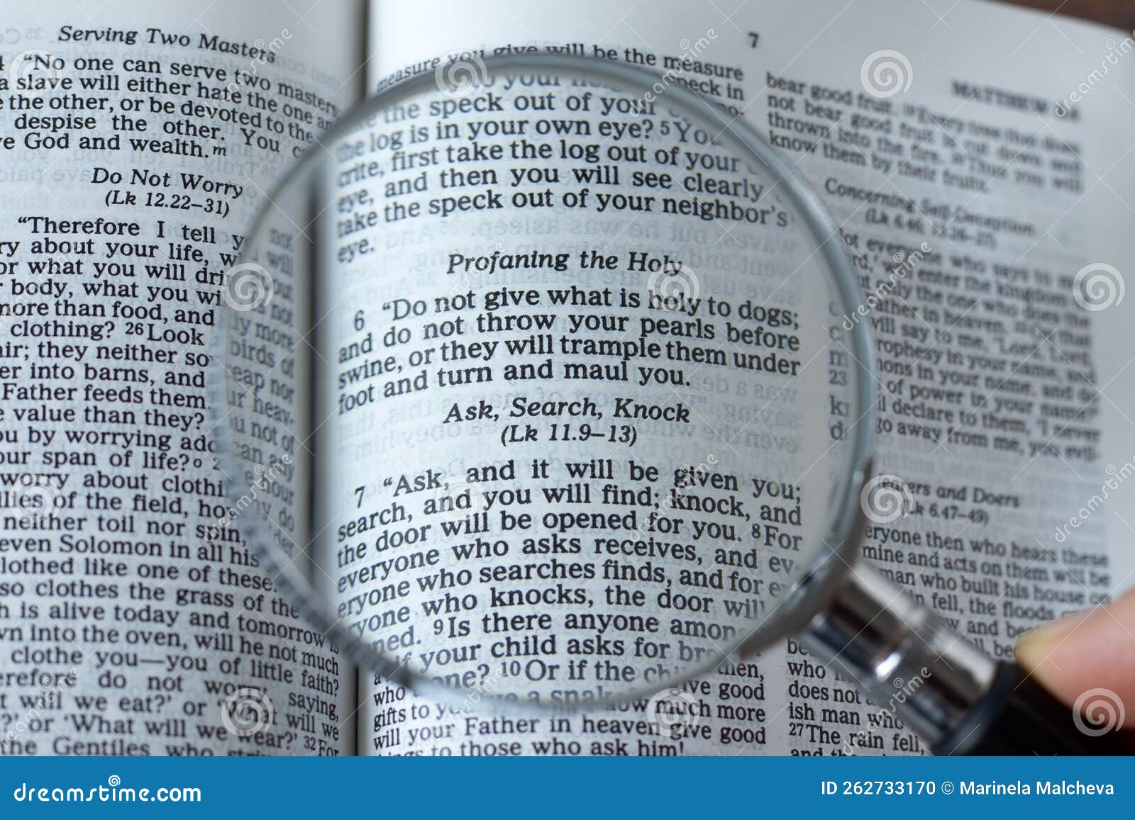 magnifying glass over open holy bible book, close-up, ask, search, knock verse, matthew 7:7 scripture text