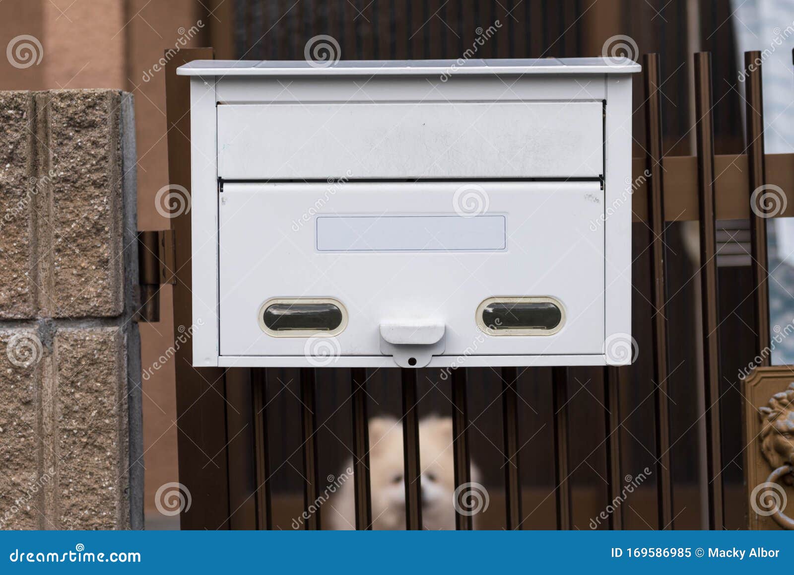 White Mailbox or Post Box at a Gate of a Residential House. Stock Image