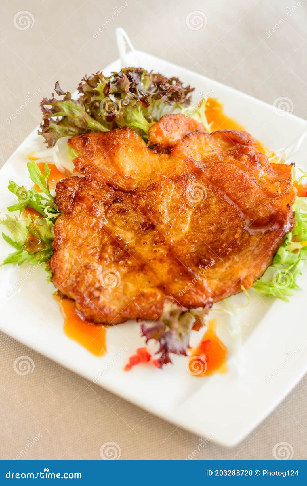 A Main Course of Panfried Pork Chop with Soy Sauce Served on Lettuce