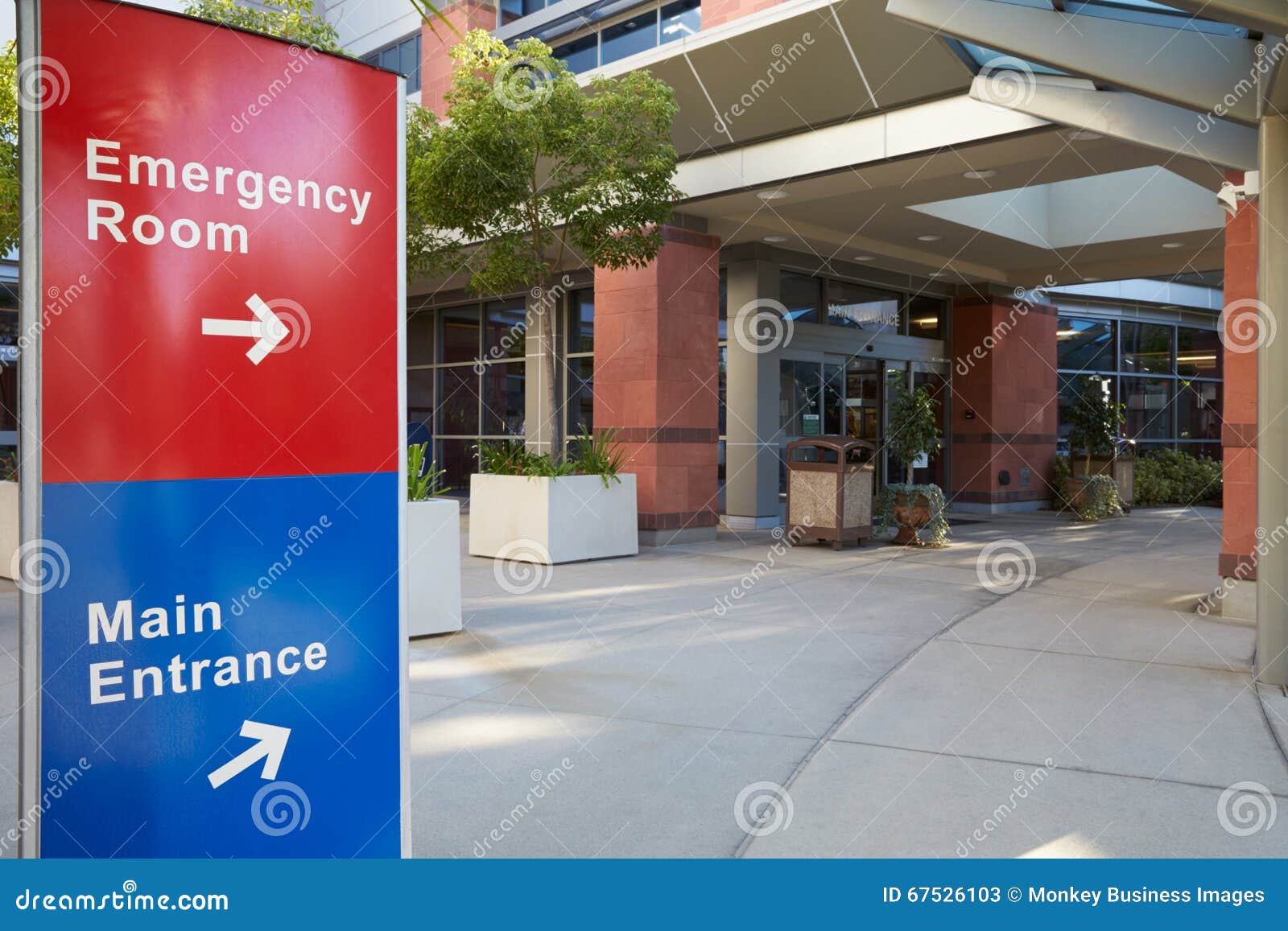 main entrance of modern hospital building with signs