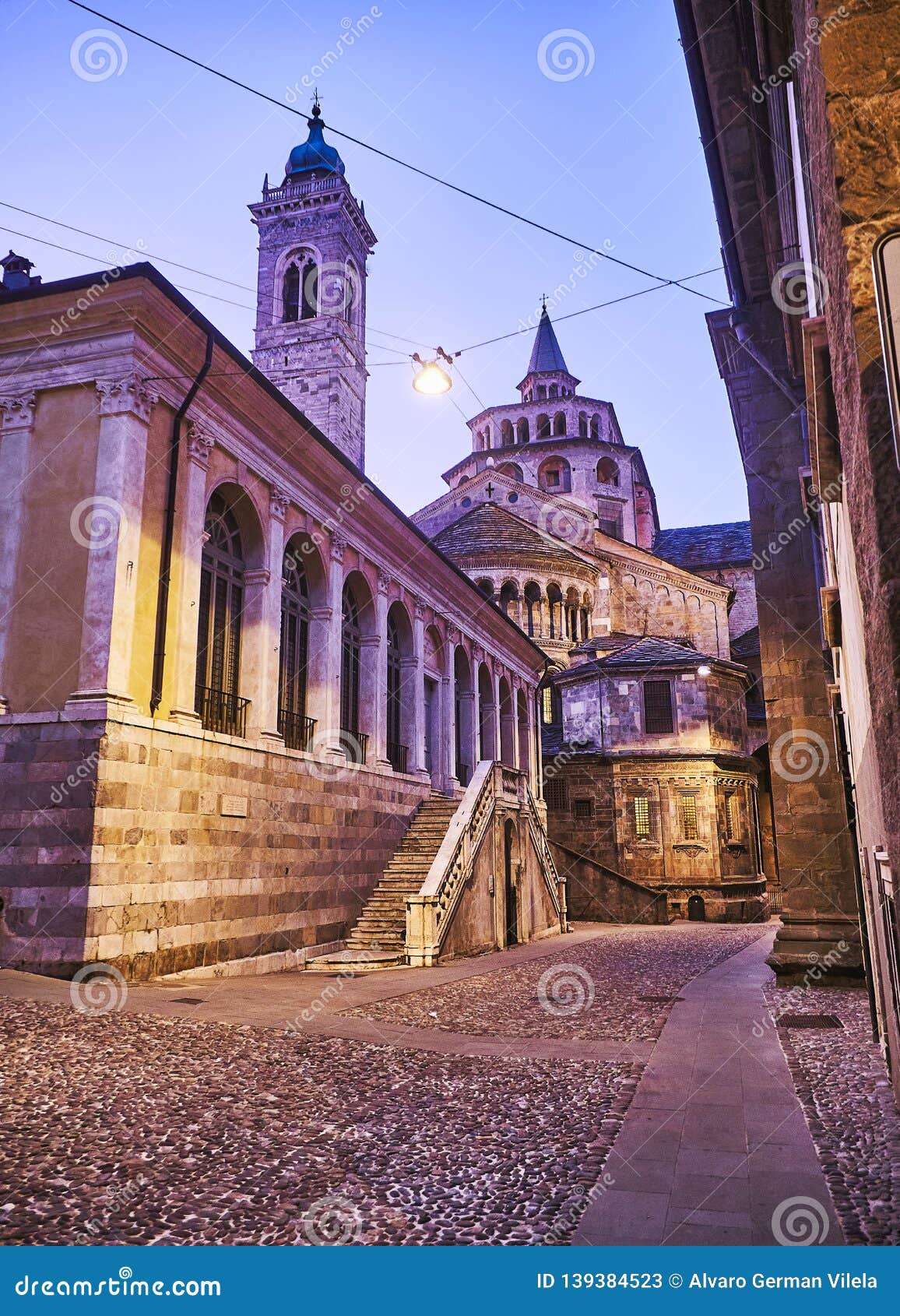 the fontanone visconteo with the basilica di santa maria maggiore in the background at nightfall. citta alta, bergamo, lombardy,