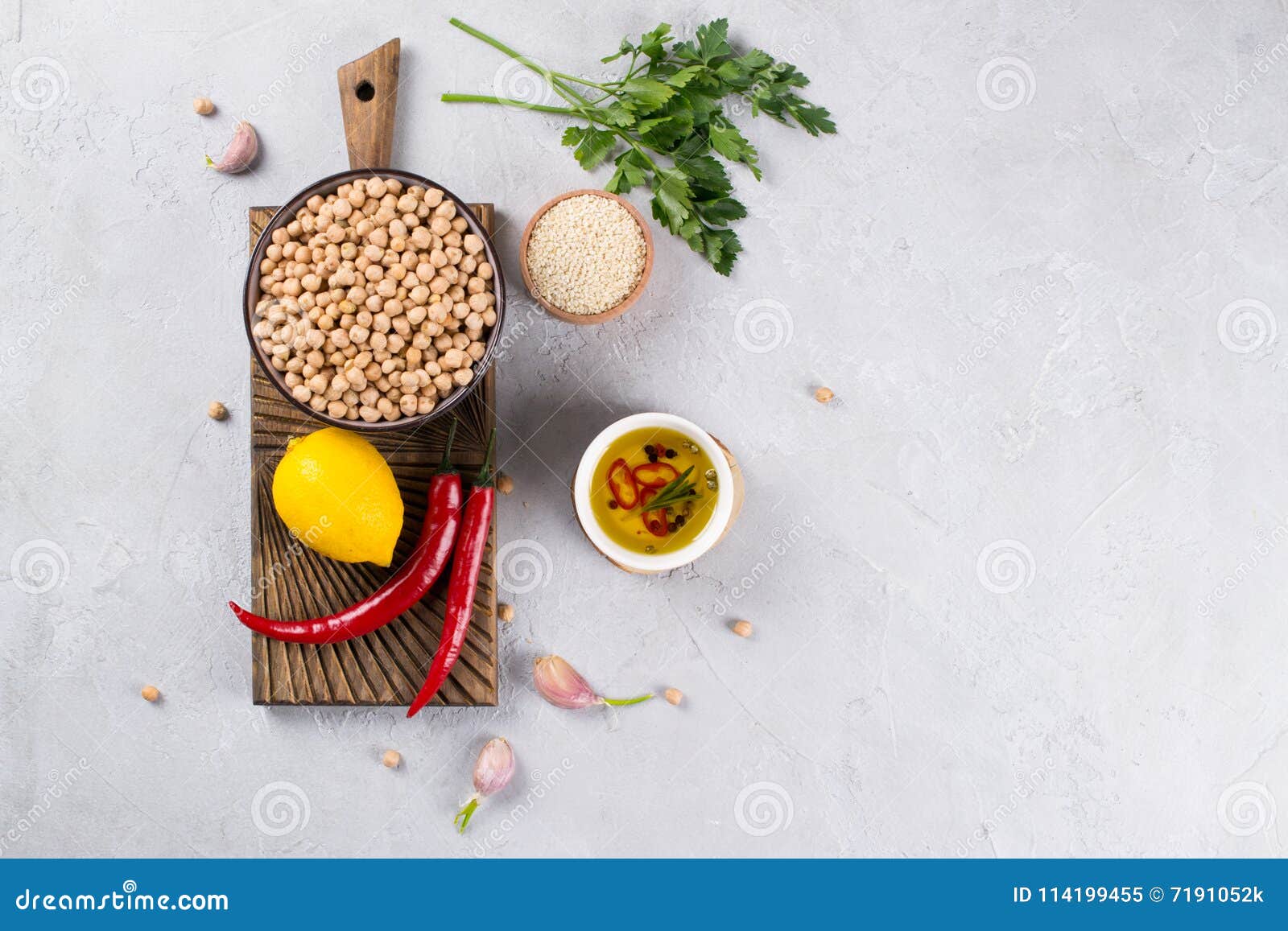 main ingredients for making hummus, chickpea, lemon, garlic, sesame, oil, pepper, parsley top view.food background