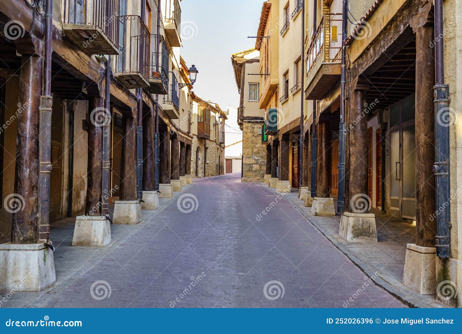 main street with medieval arcades made of wooden columns in san estaban de gormaz, soria.