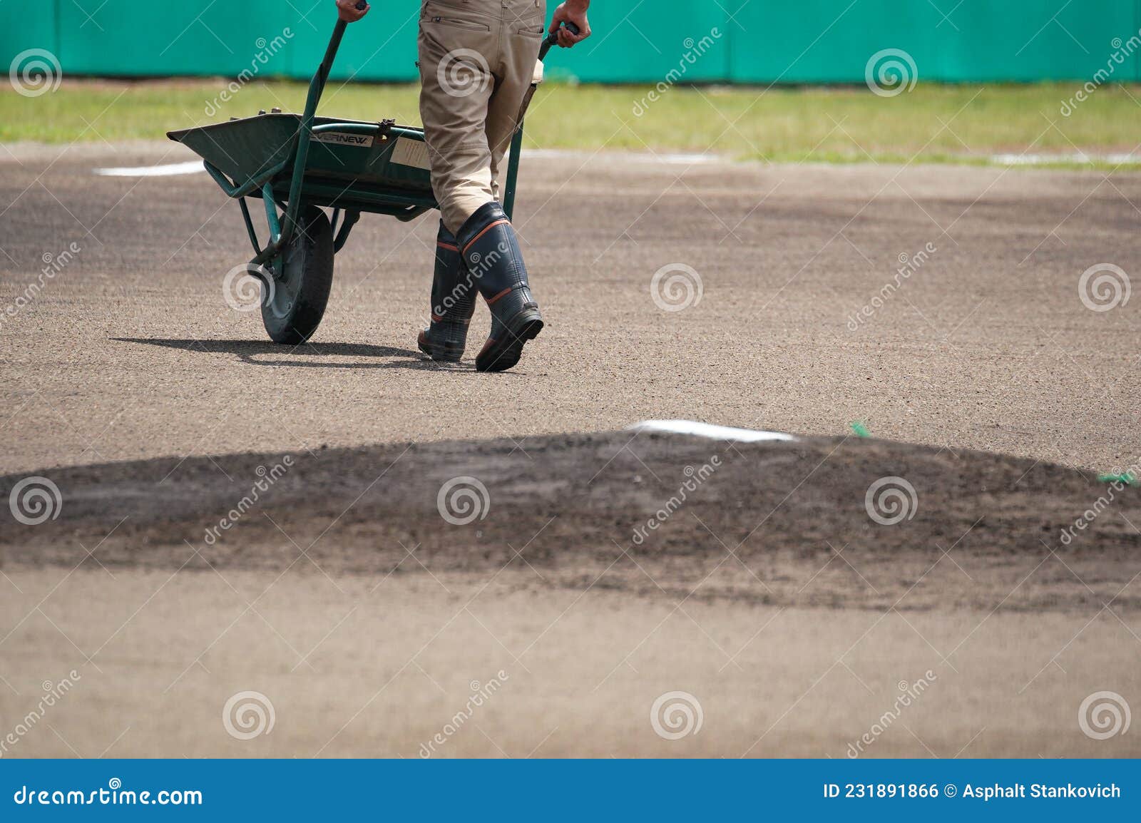 A Maintenance Worker on the Baseball Field for a Game. Stock Photo