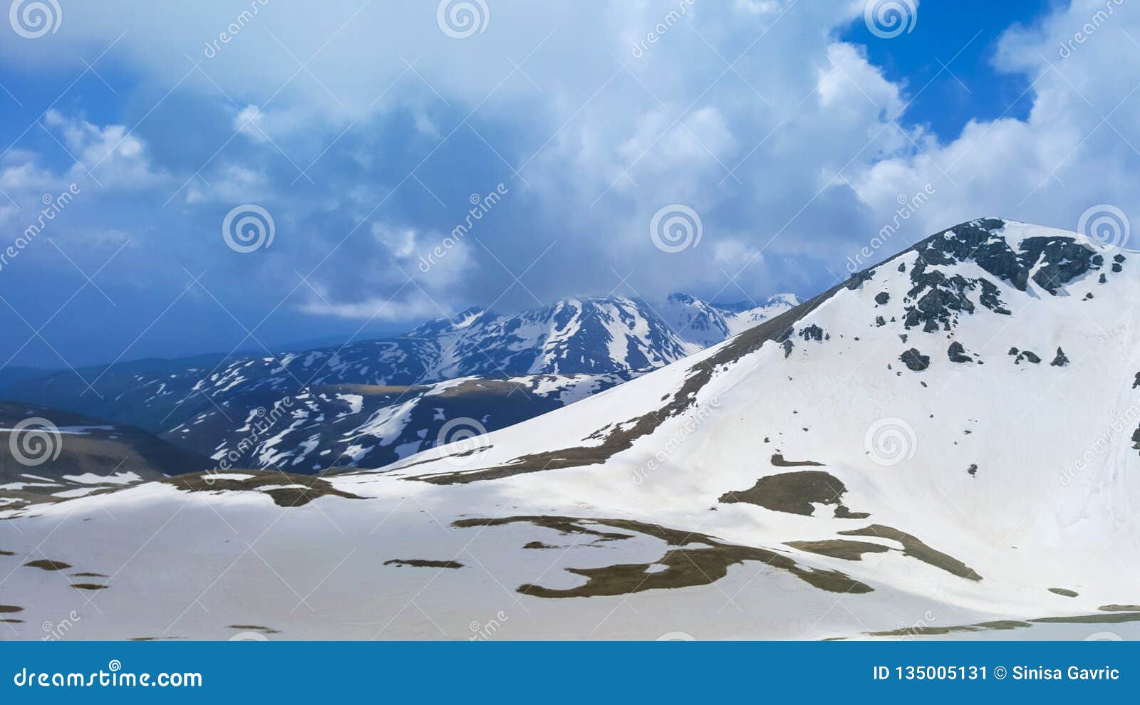 Majestic Mountain Peaks Covered With Snow And Soaring Blue Skies Stock