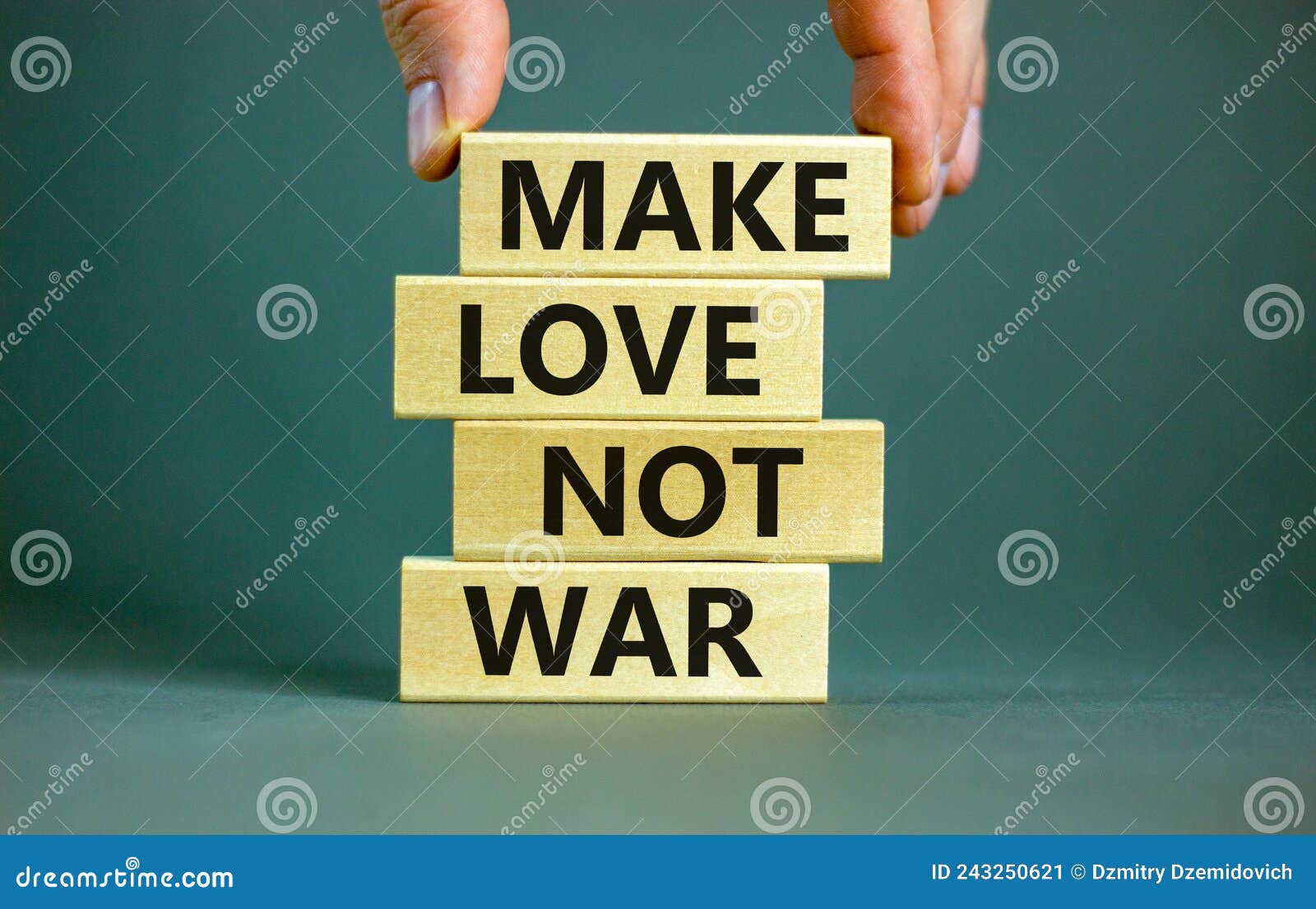 make love not war . concept words make love not war on wooden blocks. businessman hand. beautiful grey table grey background