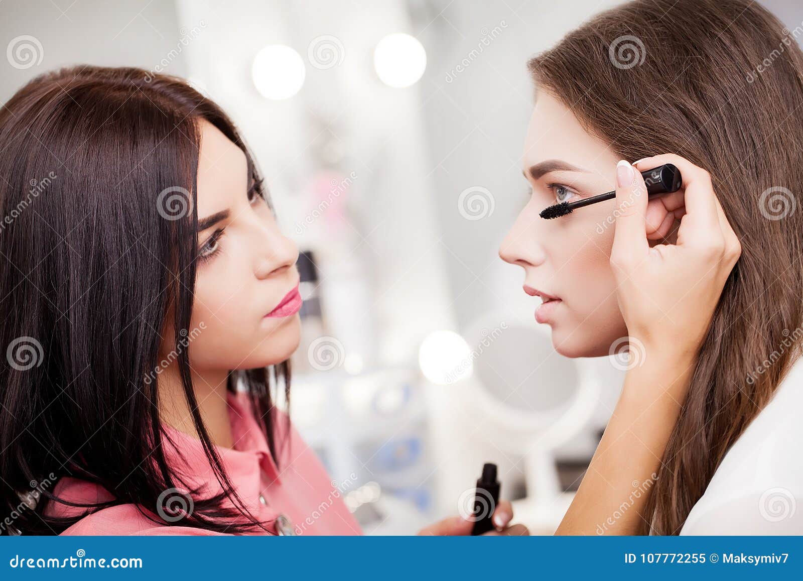 Makeup Artist Applying Bright Base Color Eyeshadow On Model`s E Stock