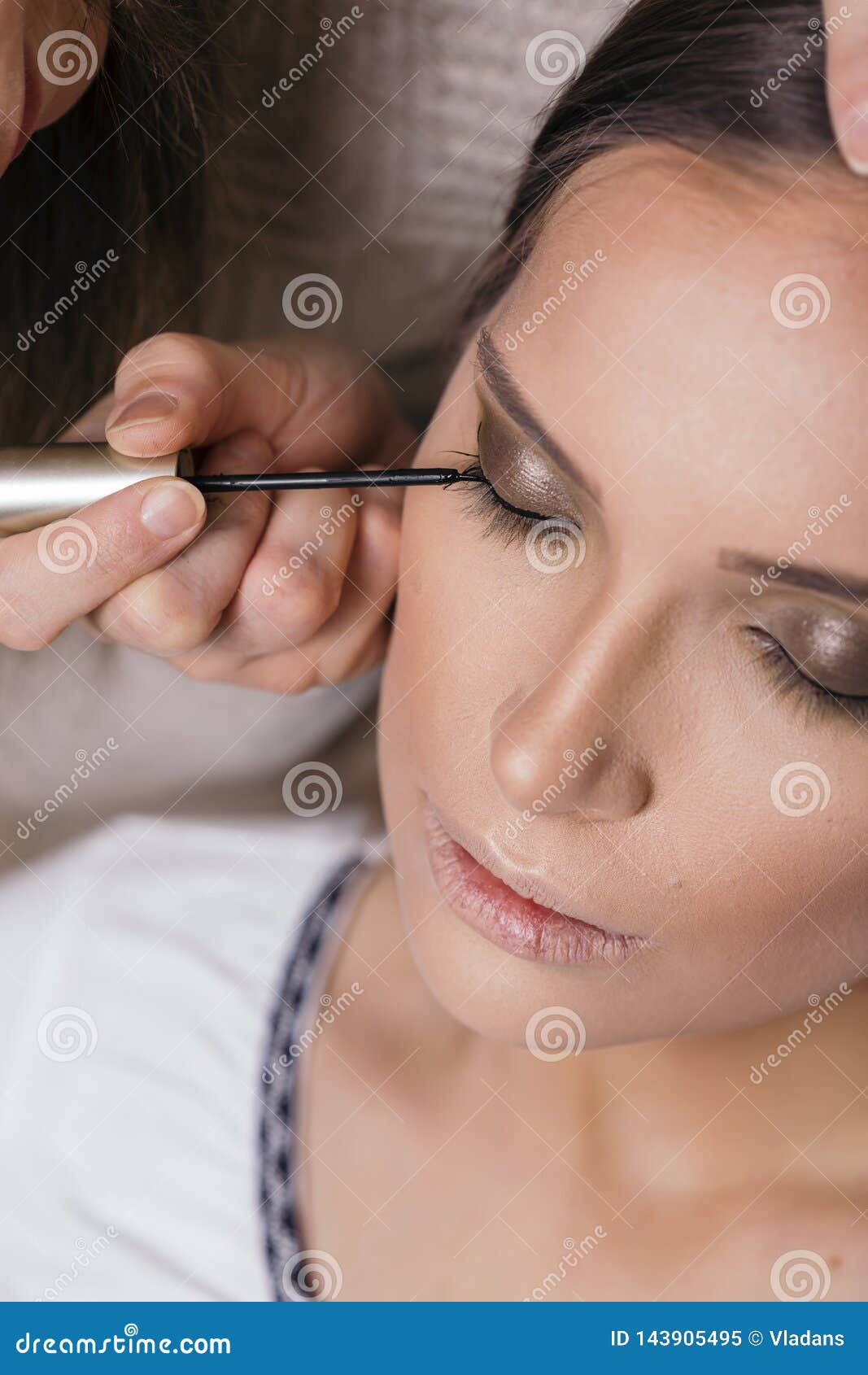 Make Up Artist Applying Eyeliner on Client`s Eyelids Stock Image