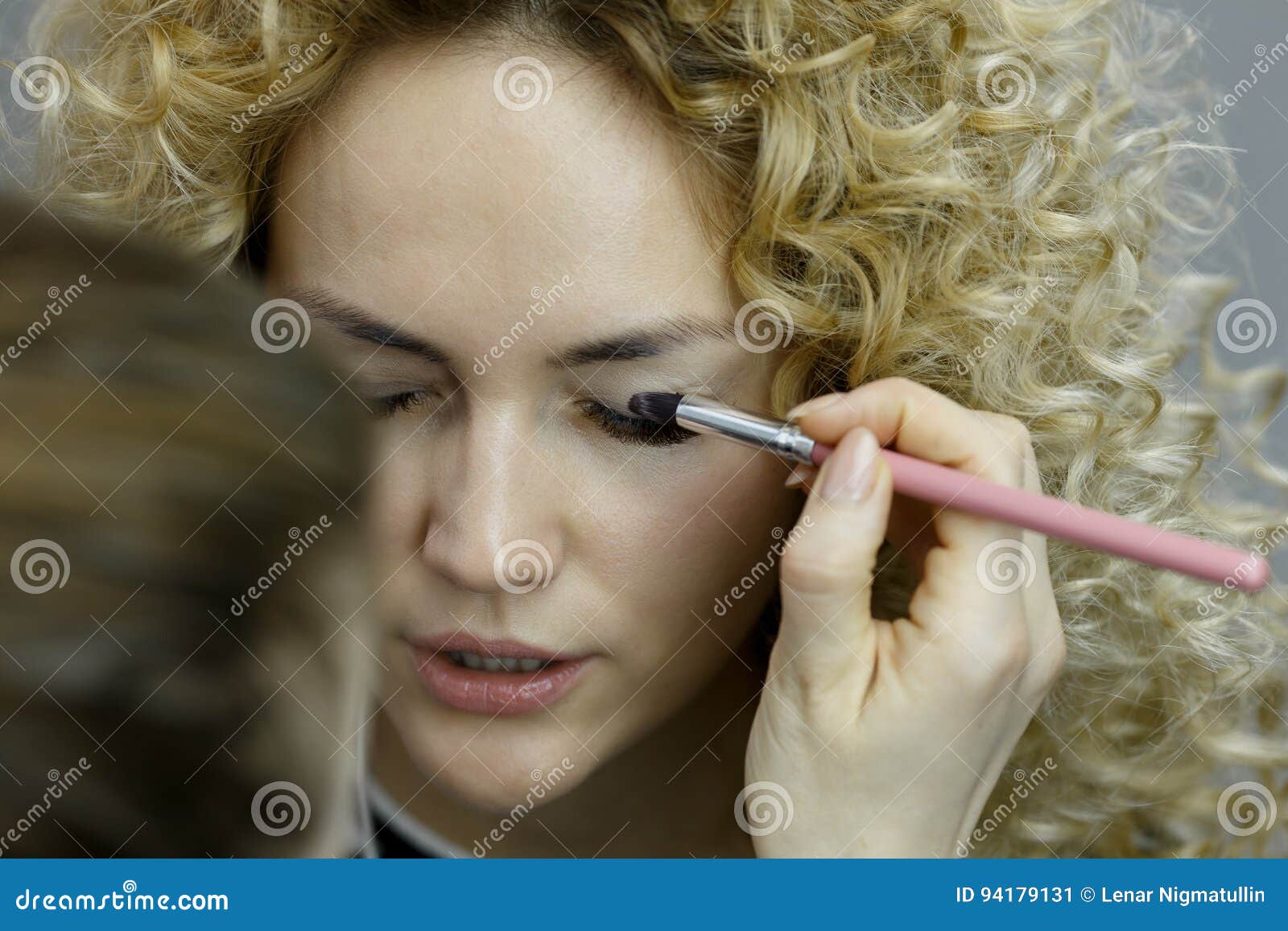 Make Up Artist Doing Professional Make Up Of Young Woman