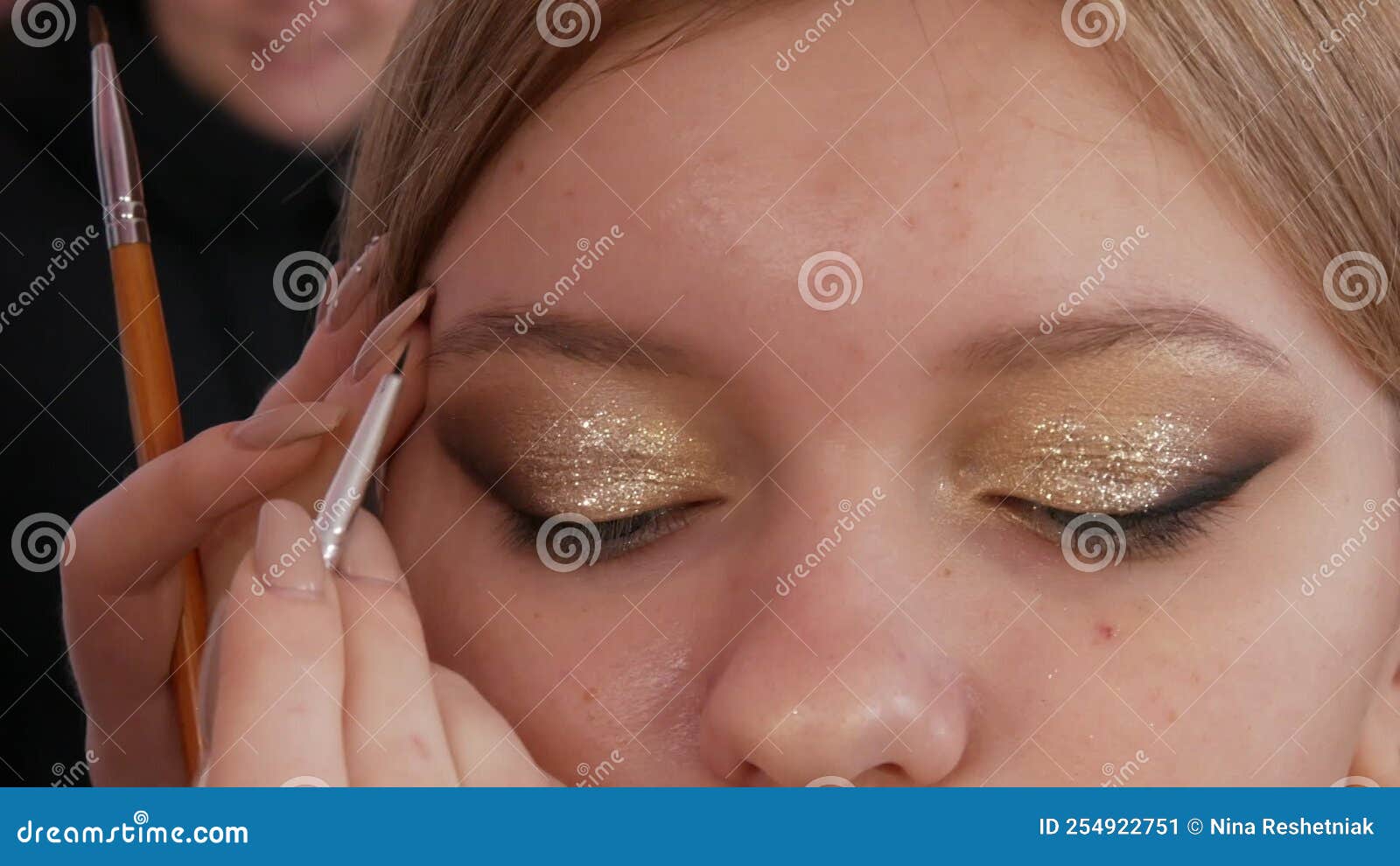Makeup Artist Makes Eye Makeup of the Model Using a Special Brush