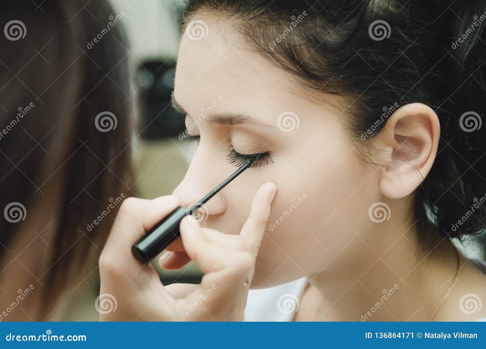The Makeup Master Paints the Eyes of the Girl. Makes Makeup, Closeup