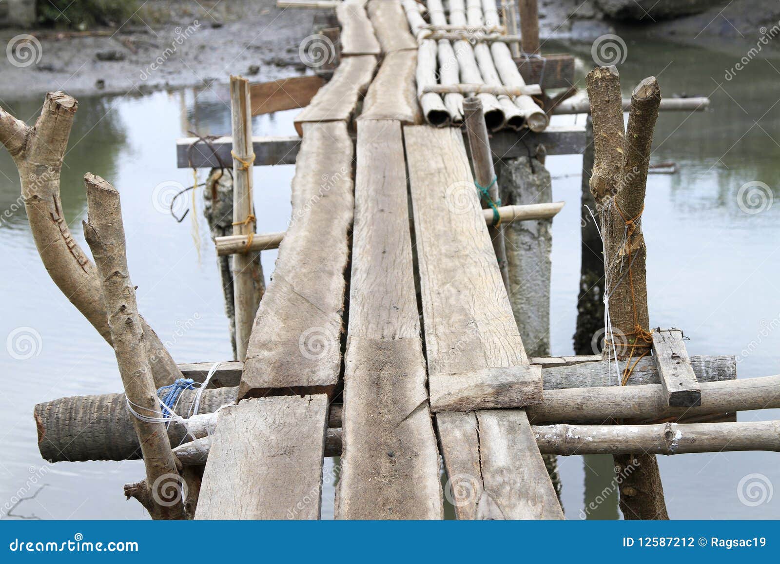 Makeshift wooden bridge over water Stock Photo - Alamy