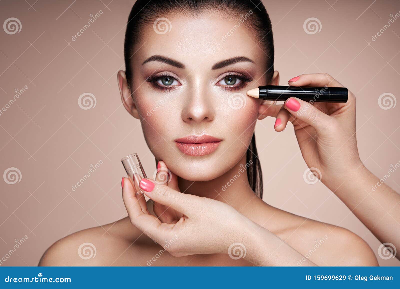makeup artist applies skintone