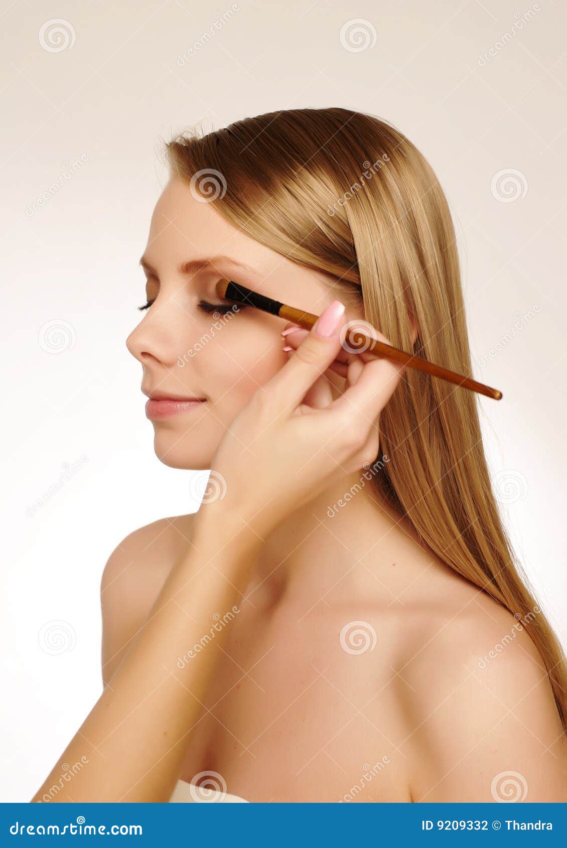 makeup artist applying mascara