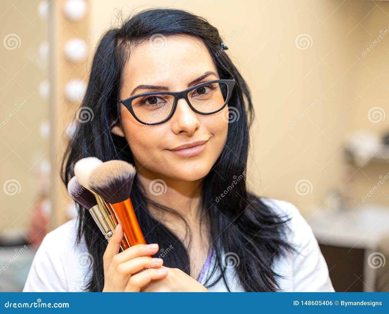 makeup artist holding brushes. makeover. perfect skin