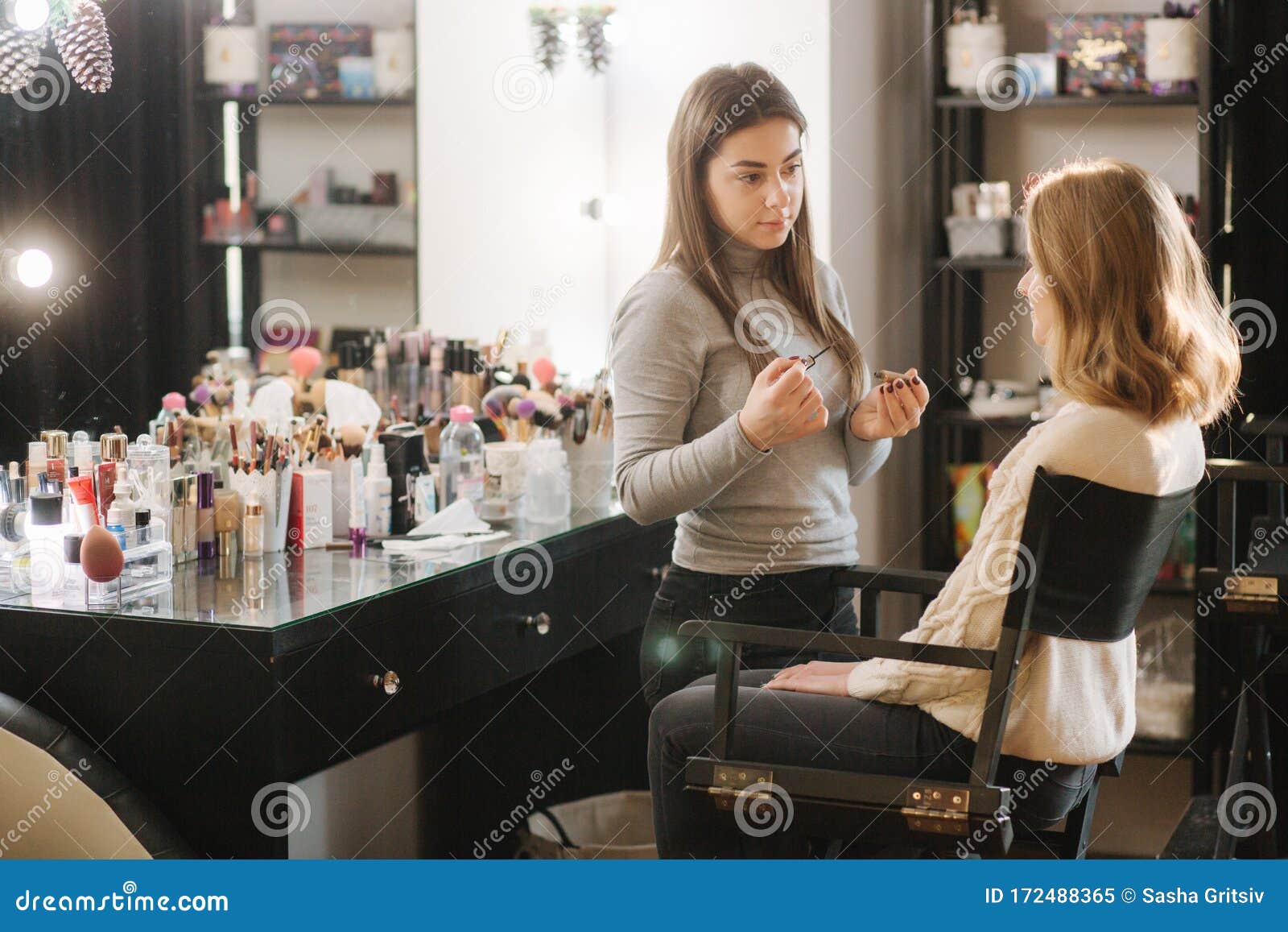 Beautiful Female Makeup Artist Doing Makeup for a Young Blond Hair Girl in a Beauty Salon Sitting in Front of a Large Stock Image - Image of people, cosmetic: 172488365 Beautiful Female Makeup Artist Doing Makeup for a Young Blond Hair Girl in a Beauty Salon Sitting in Front of a Large Stock Image - Image of people, cosmetic: 172488365