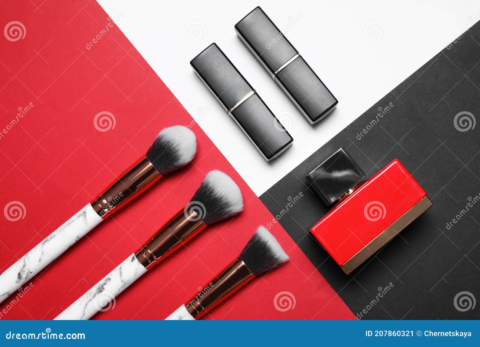 Makeup Brushes, Lipsticks and Bottle of Perfume on Color Background