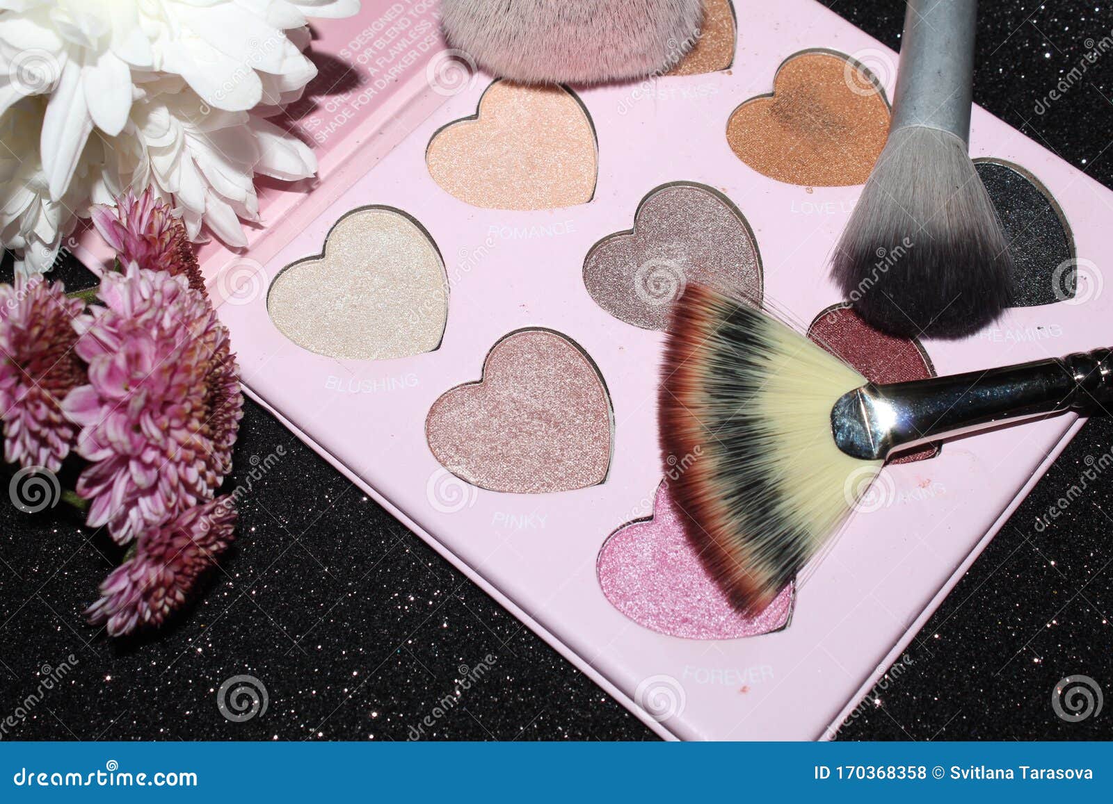 Makeup Brushes with White Flowers and Eye Shadows. Stock Photo Image