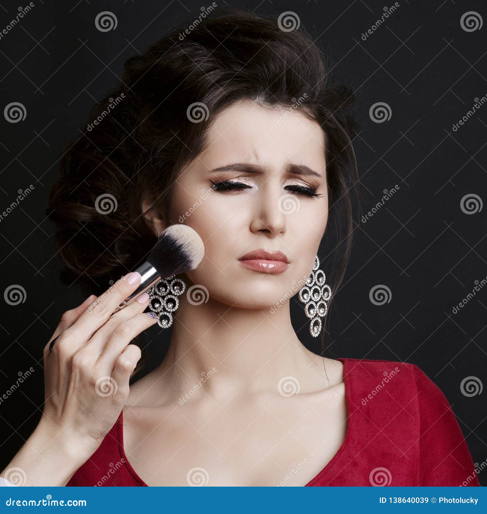 makeup on cheekbone with for capricious brunette girl.
