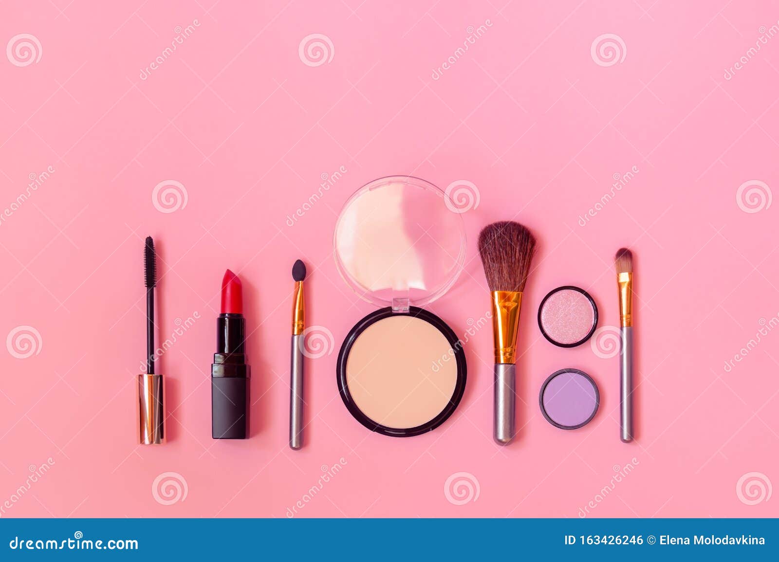 Makeup Cosmetics and Brushes As Border on Pink Background. Top View