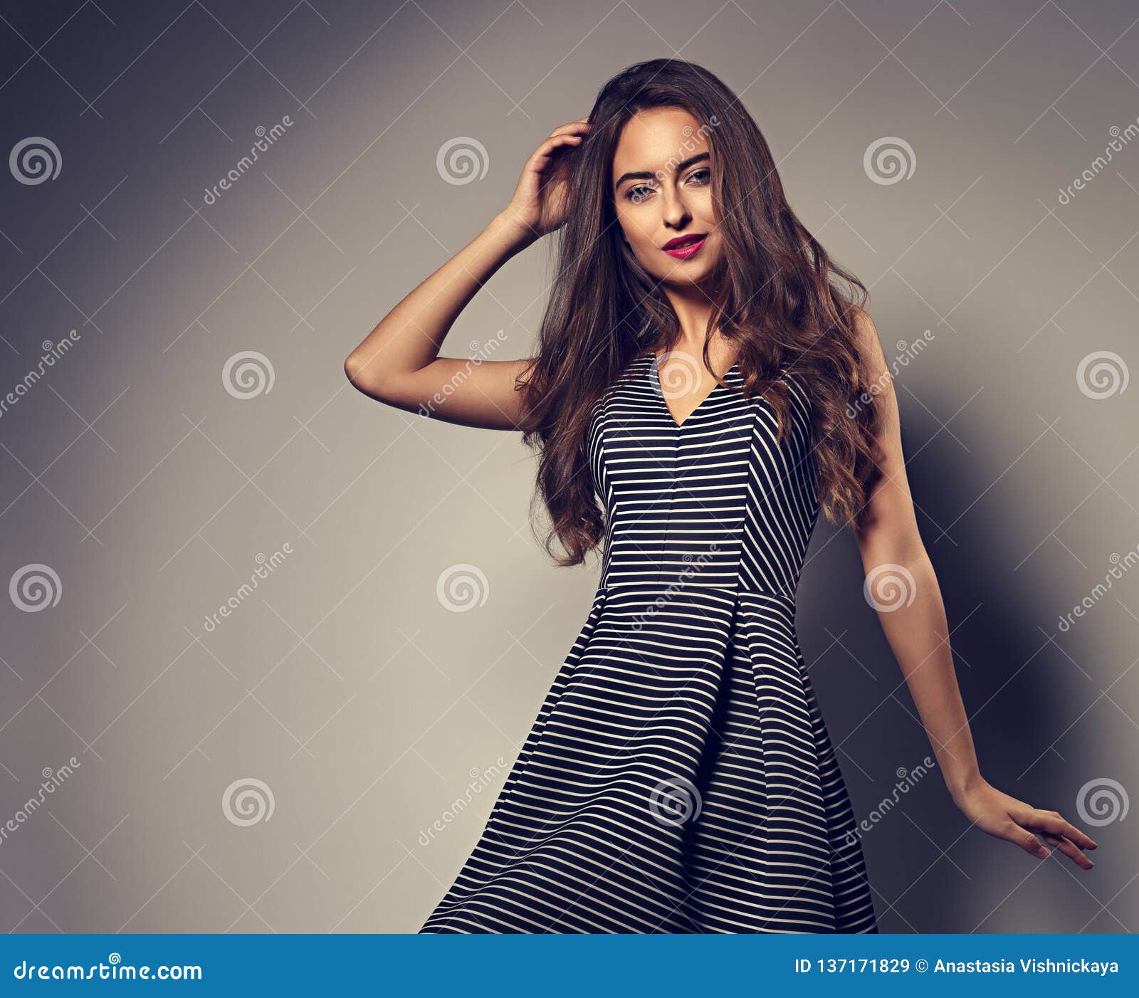 Makeup Woman With Long Curly Hairstyle Posing In Fashion