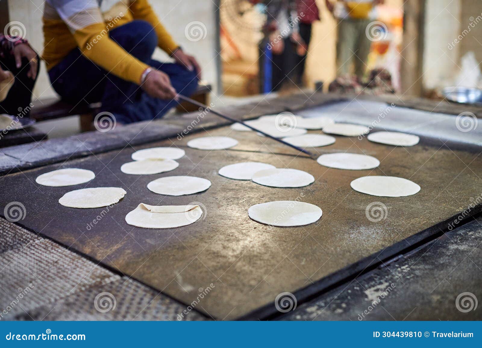 making of chapati round flatbreads for langar in sikh gurudwara temple many uncooked roti flatbreads