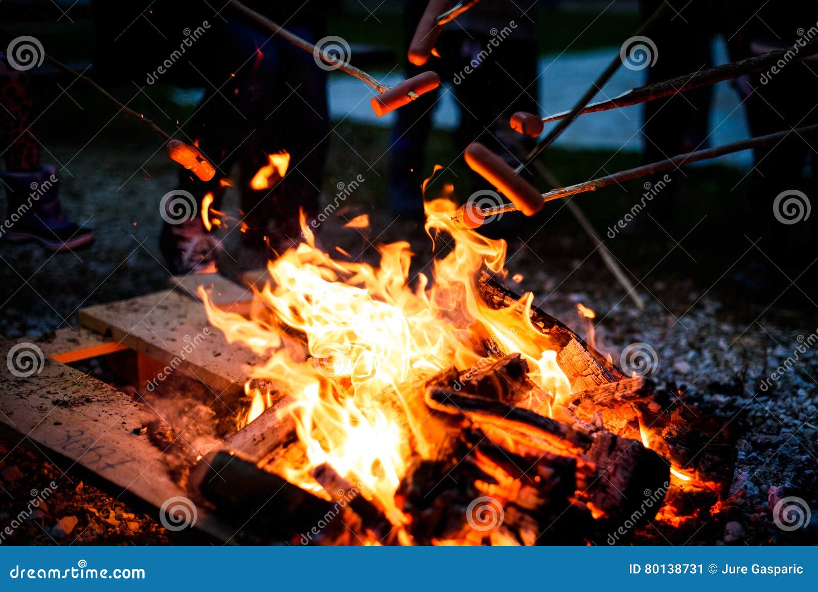 Making and Cooking Hot Dog Sausages Over Open Camp Fire. Stock Image ...