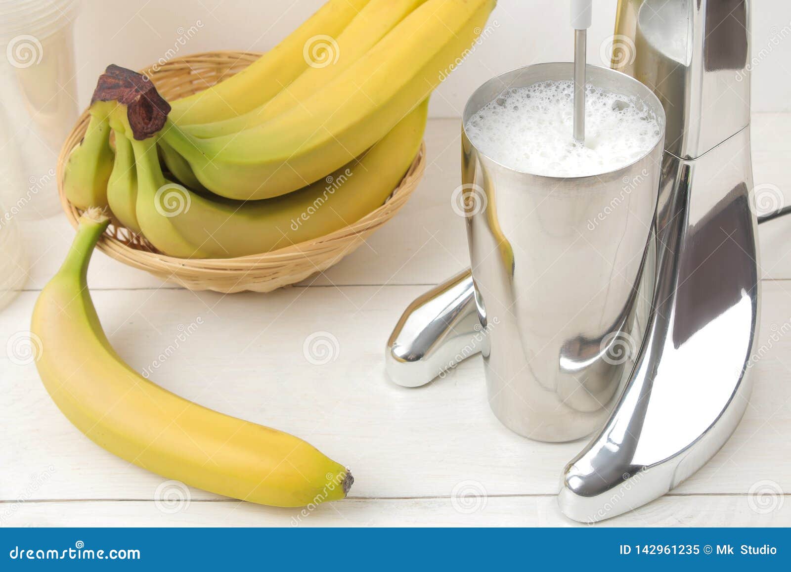 Making a Milkshake. Mixer for Milkshake and Bananas on a Light