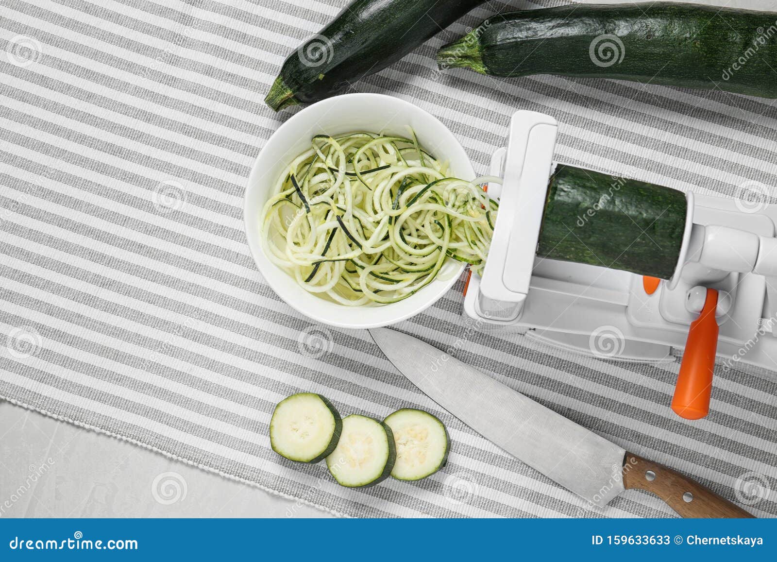 Making Zucchini Noodles with Spiral Slicer on Table Stock Image