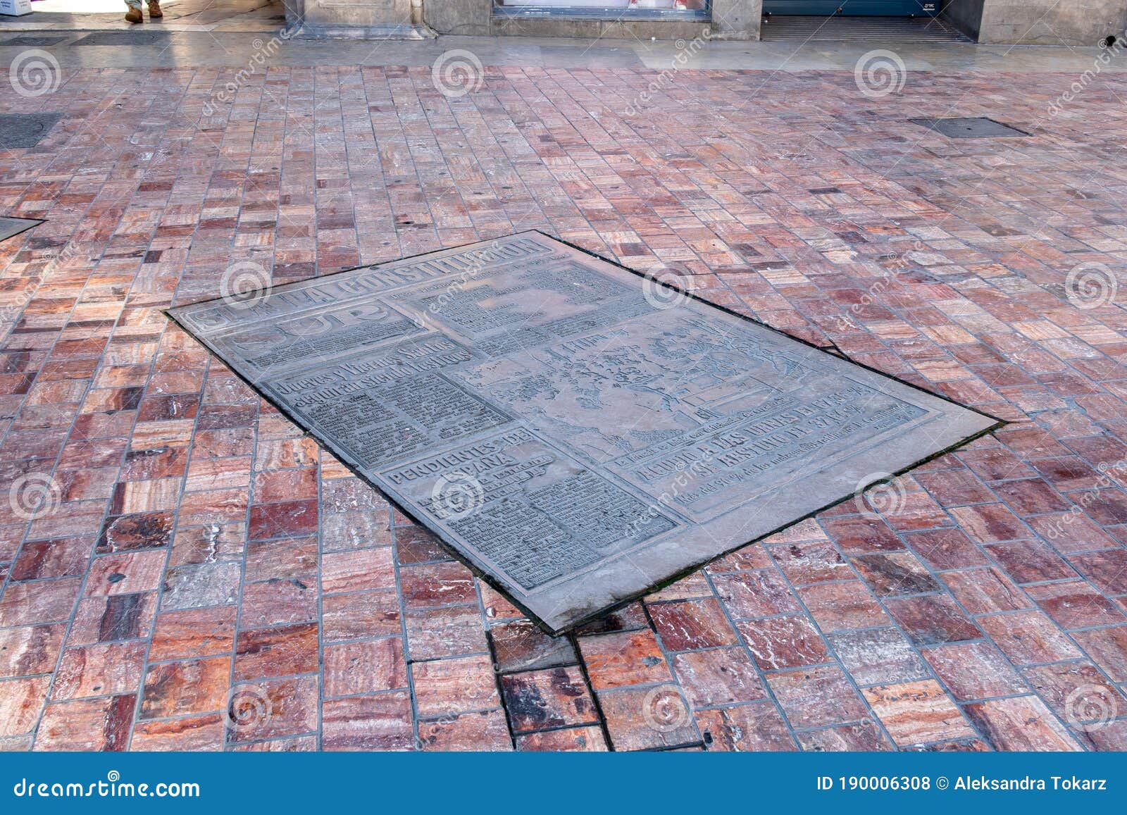 plaza de la constitucion in malaga with old newspaper front page tile panel dated 7 december 1978, spain