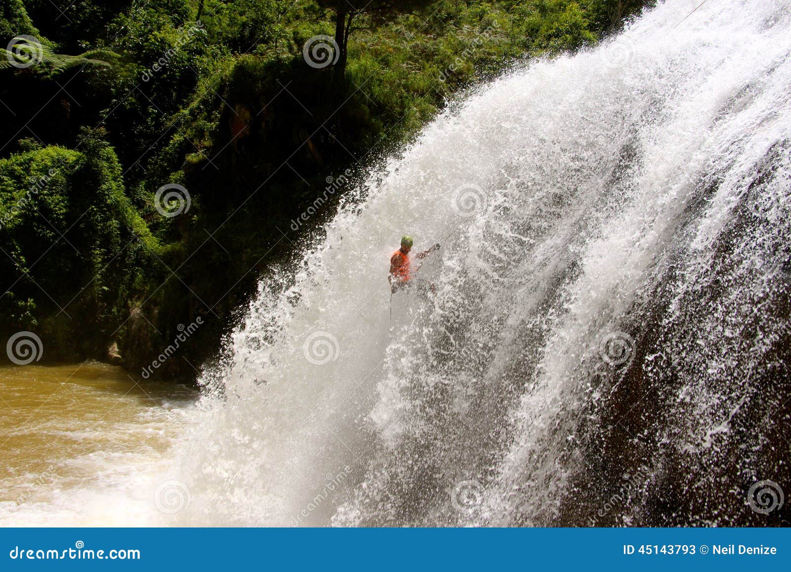 male abseils massive waterfall