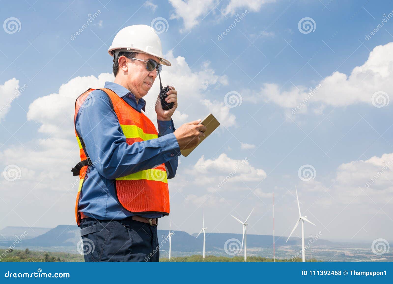 male architect or engineer use two way radio and tab;et
